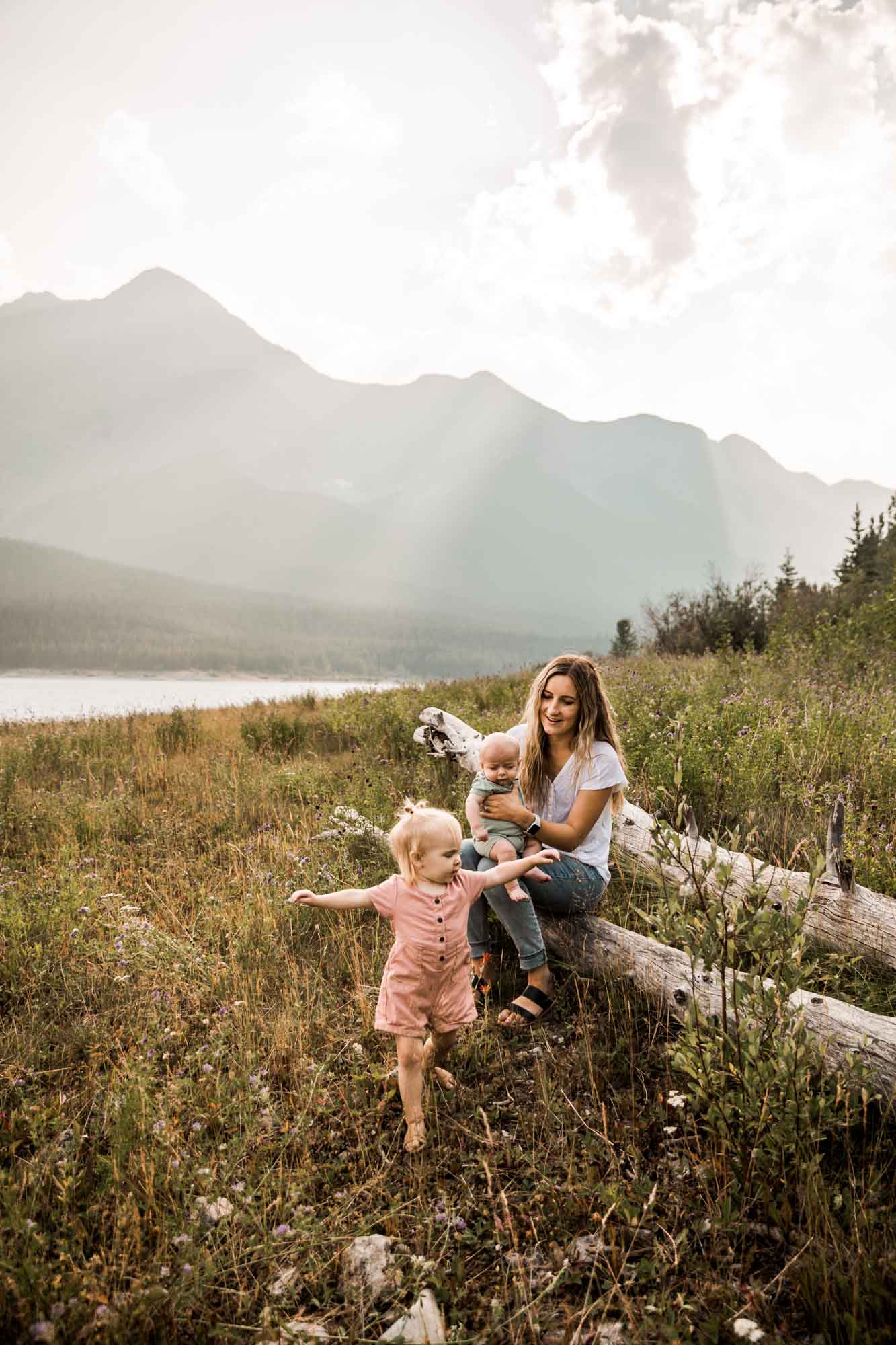 Calgary lifestyle family photographer, family photos by the water and mountains at sunset in Kananaskis Country