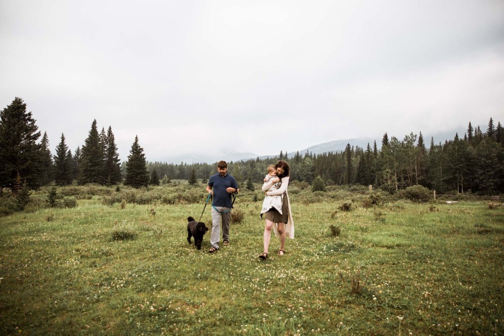 Calgary family photographer, mountain photos, family in a fields in front of a mountain