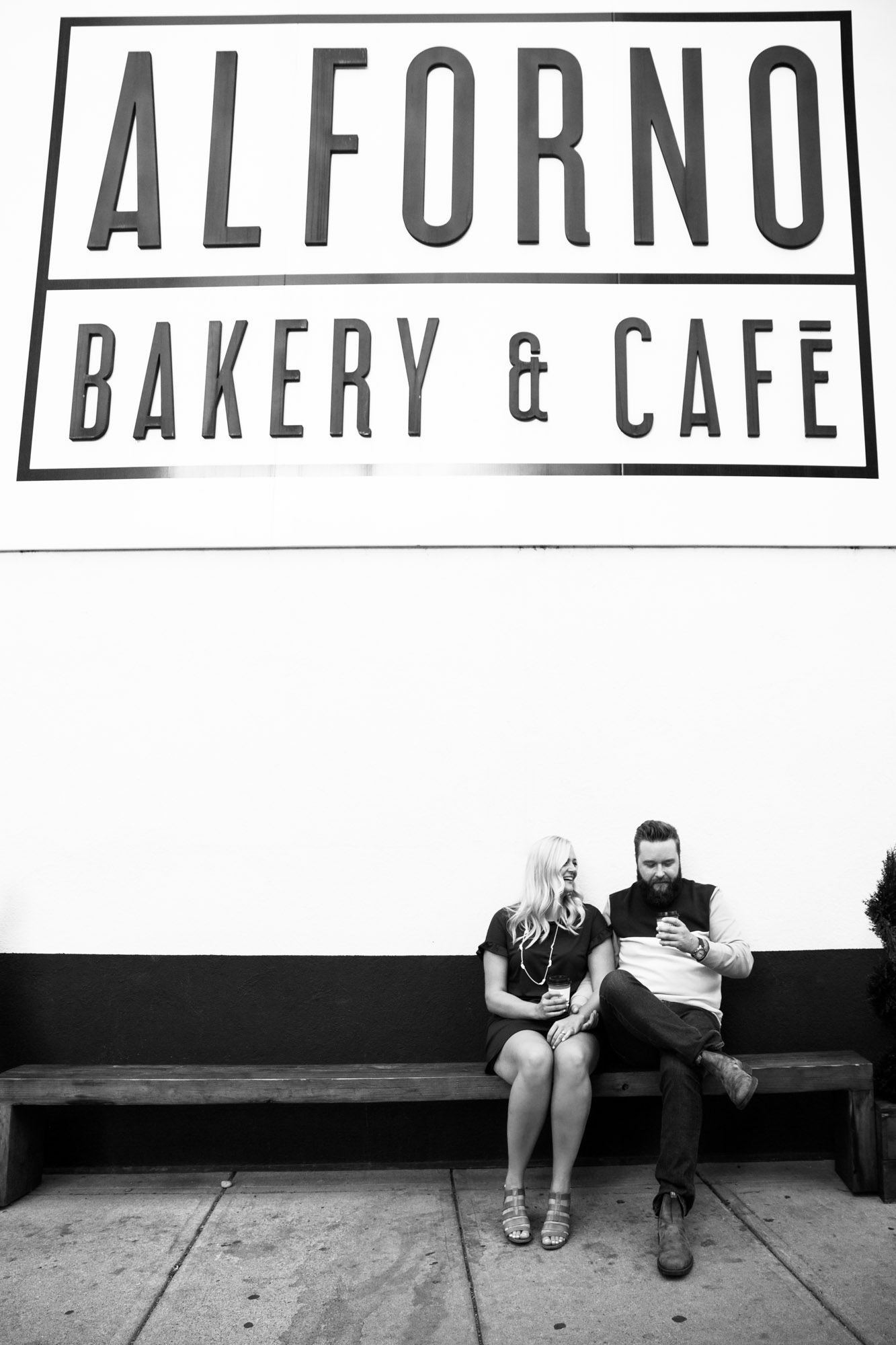 Calgary wedding photographer, engagement photos at Alforno Bakery and Cafe, couple sitting on a bench outside