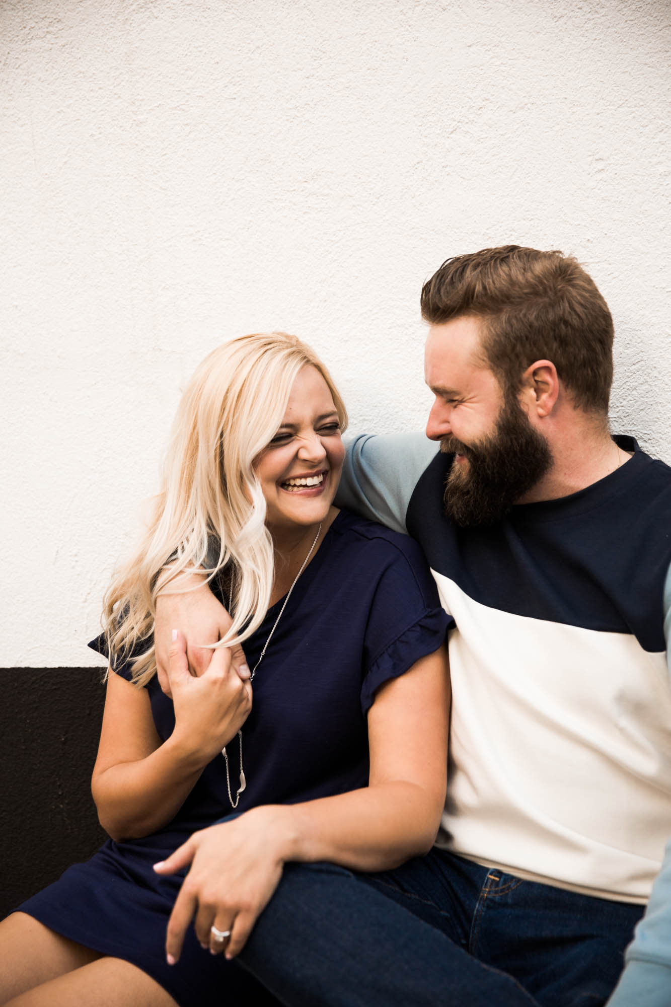 Calgary wedding photographer, engagement photos at Alforno Bakery and Cafe, couple sitting on a bench outside