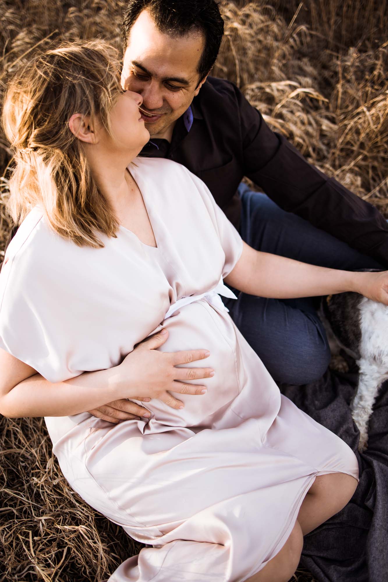 Calgary maternity and newborn photographer, couple at sunset in the golden light of the sun, mom with a beautiful pregnant belly