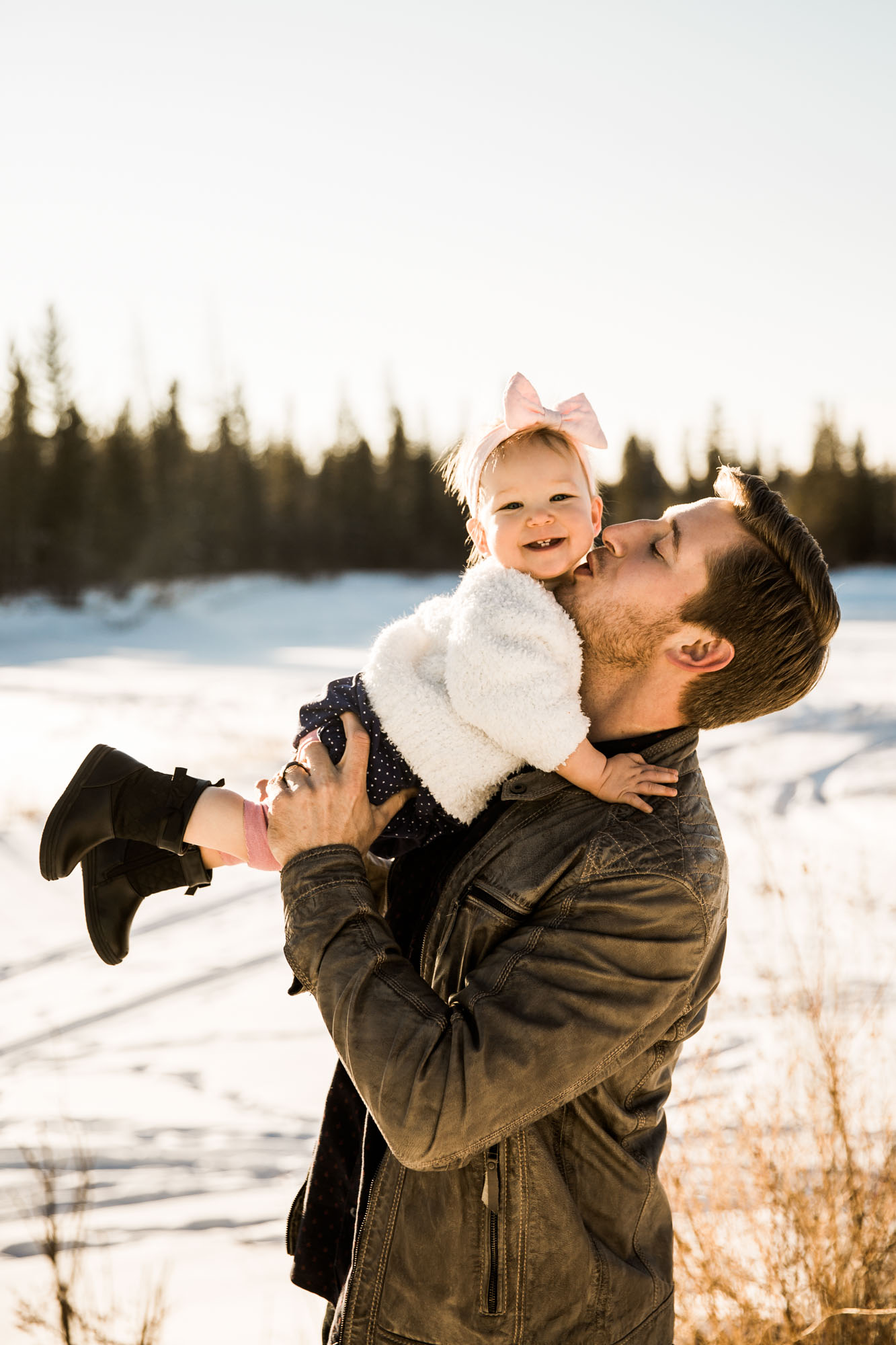 Calgary lifestyle family photographer, winter family photos at sunset at Weaslehead Flats, mom, dad and daughter in beautiful golden light