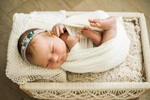 Calgary newborn and maternity photographer, in-home lifestyle photos with a family holding their newborn baby