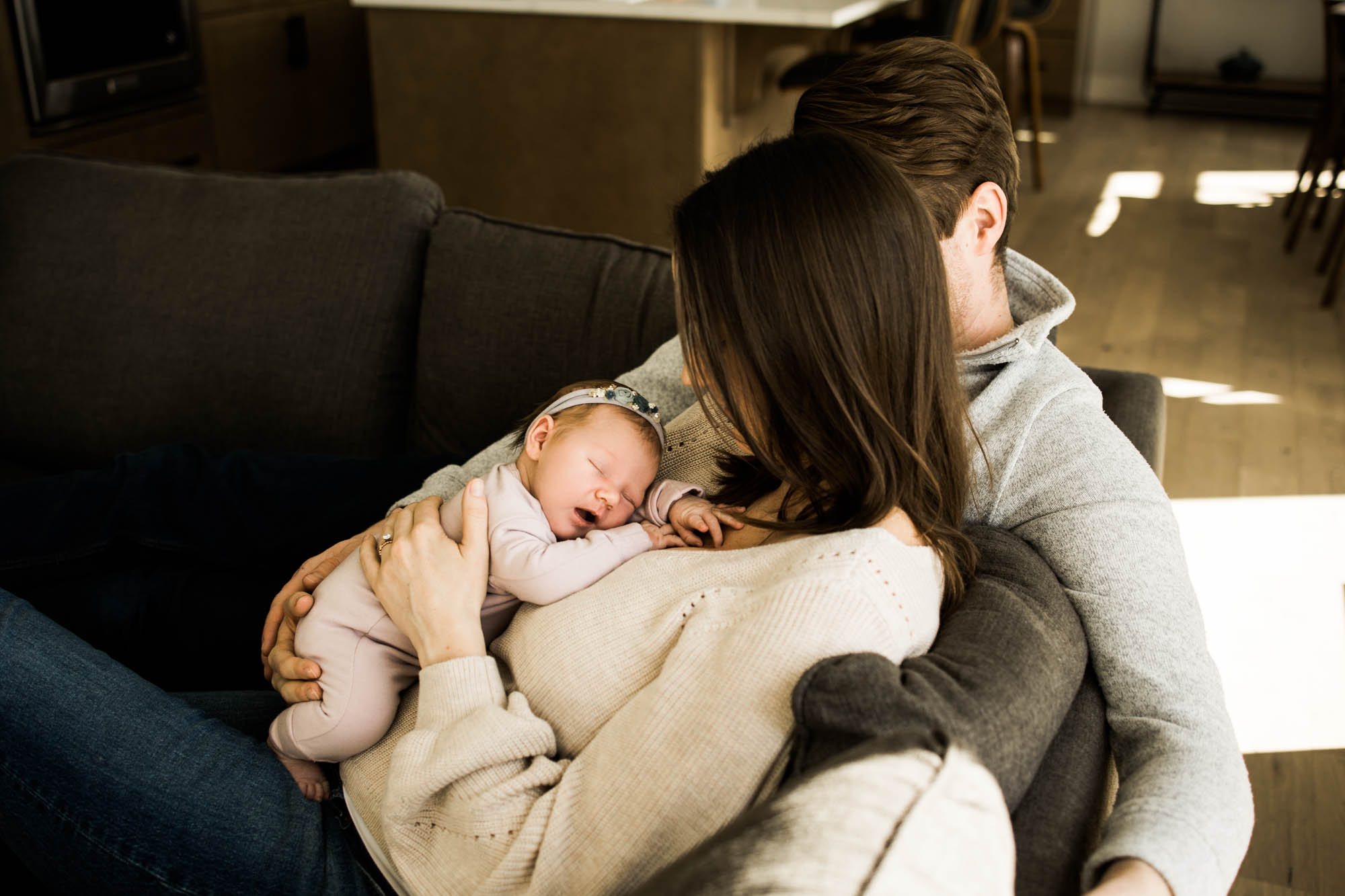 Calgary newborn and maternity photographer, in-home lifestyle photos with a family holding their newborn baby