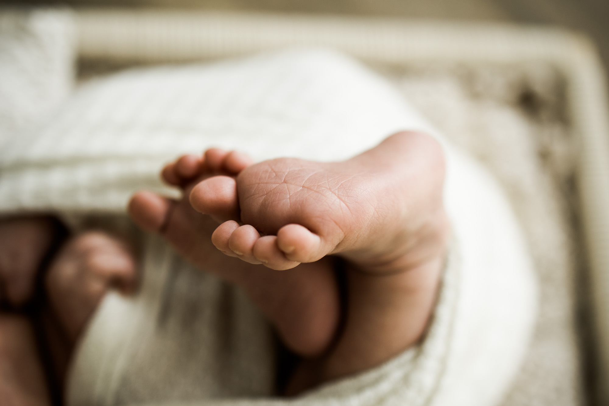 Calgary newborn and maternity photographer, in-home lifestyle photos with a family holding their newborn baby