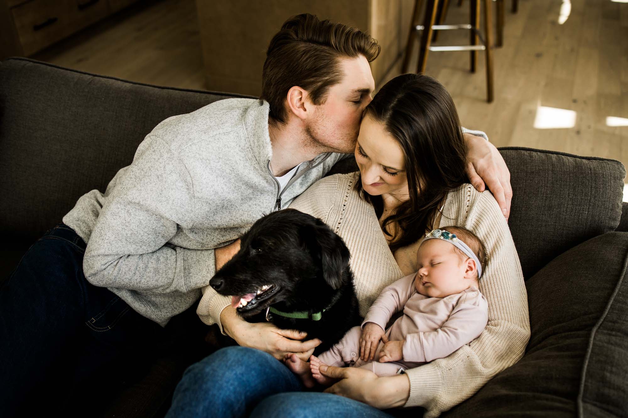 Calgary newborn and maternity photographer, in-home lifestyle photos with a family holding their newborn baby