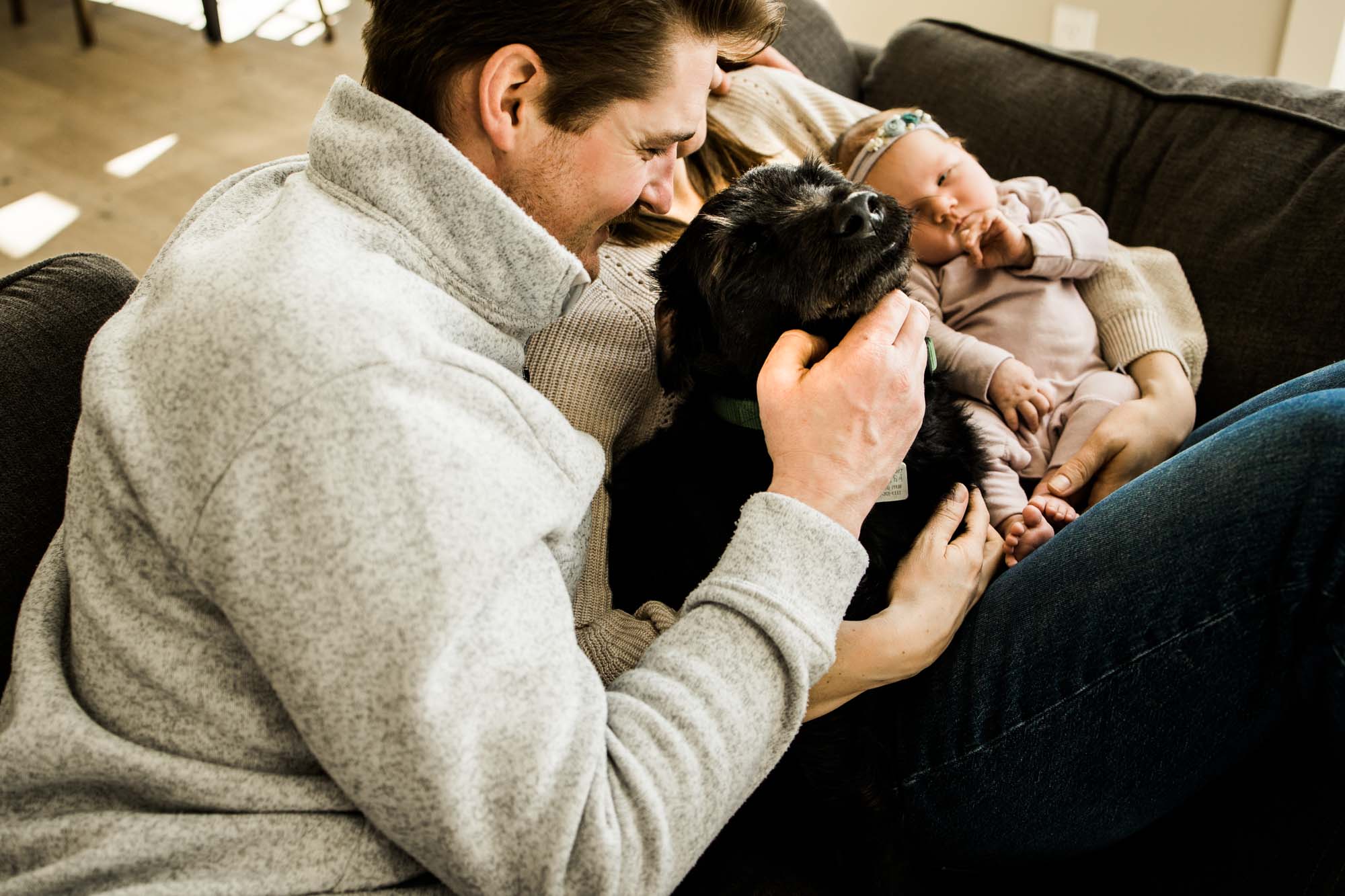 Calgary newborn and maternity photographer, in-home lifestyle photos with a family holding their newborn baby