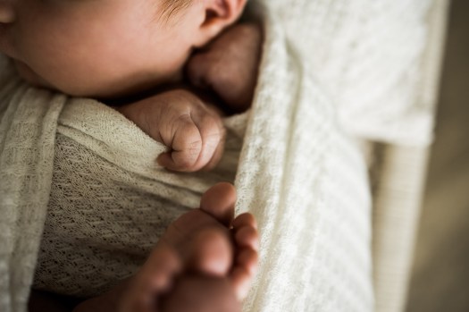 Calgary newborn and maternity photographer, in-home lifestyle photos with a family holding their newborn baby