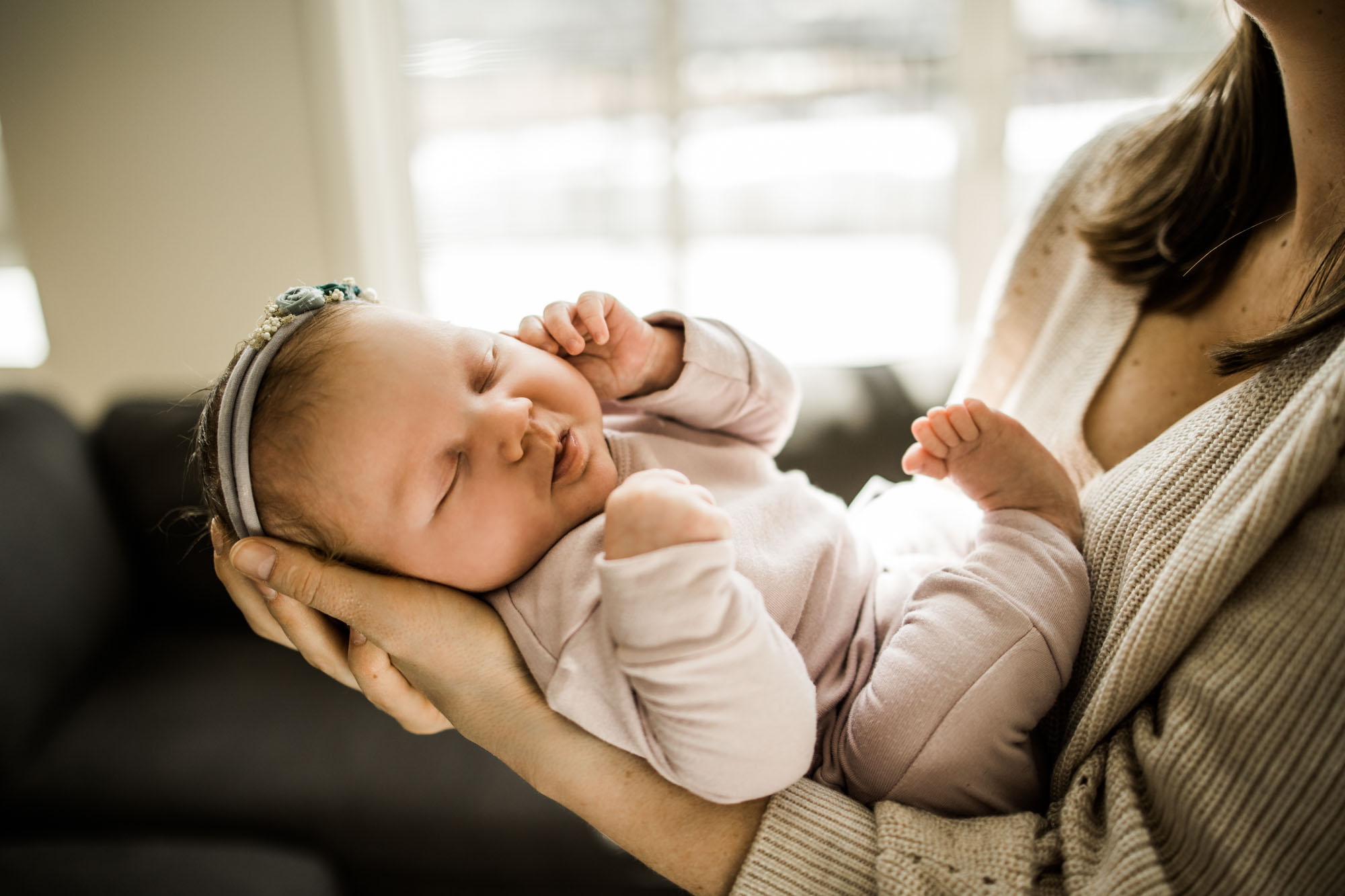Calgary newborn and maternity photographer, in-home lifestyle photos with a family holding their newborn baby