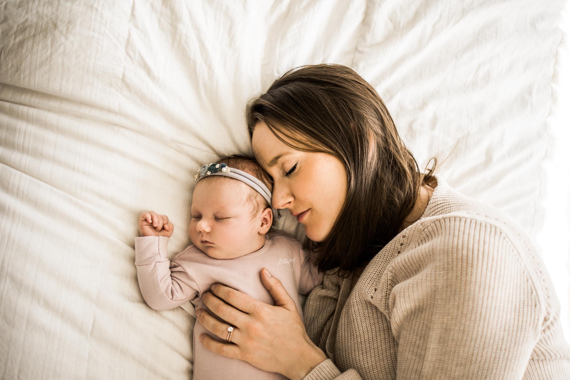 Calgary newborn and maternity photographer, in-home lifestyle photos with a family holding their newborn baby
