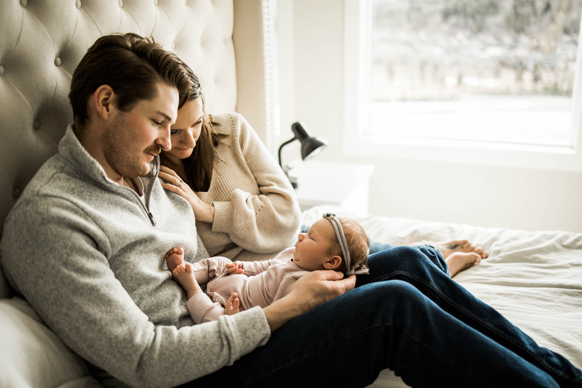 Calgary newborn and maternity photographer, in-home lifestyle photos with a family holding their newborn baby