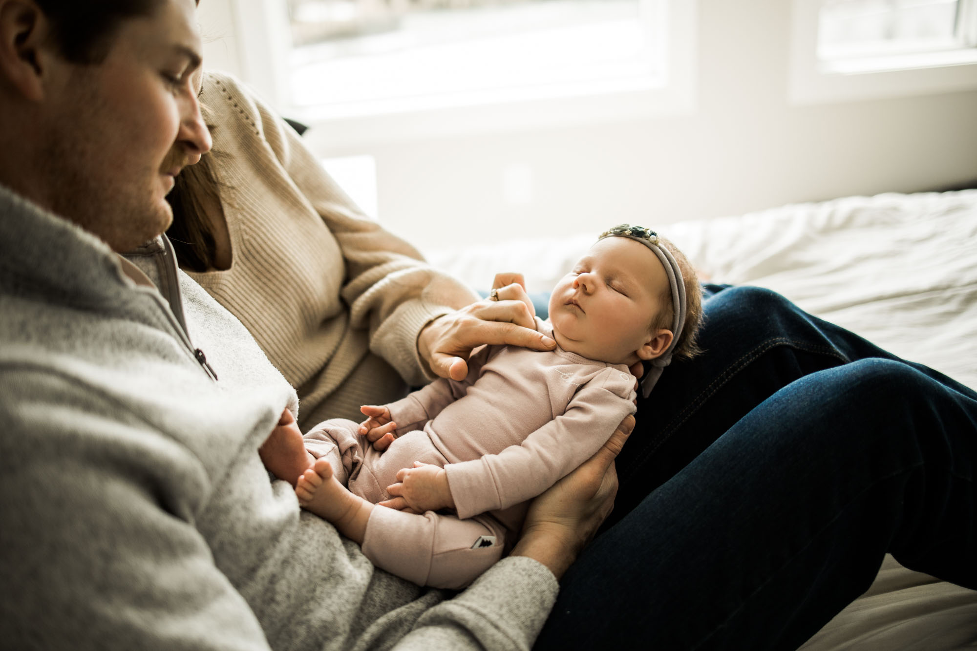 Calgary newborn and maternity photographer, in-home lifestyle photos with a family holding their newborn baby