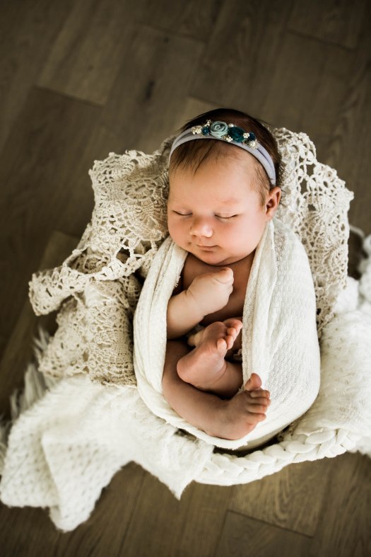 Calgary newborn and maternity photographer, in-home lifestyle photos with a family holding their newborn baby