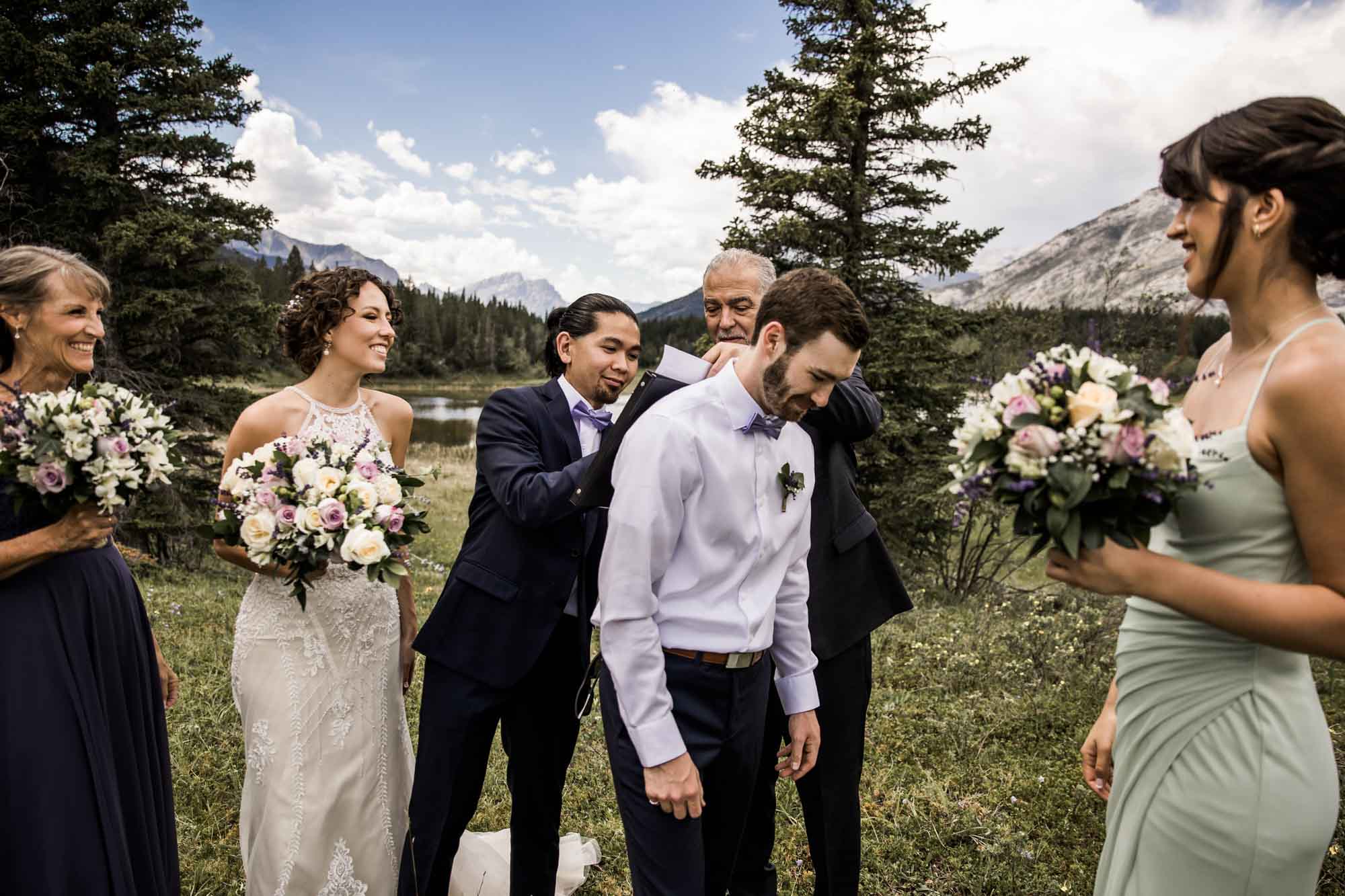 Calgary and Kananaskis Country wedding photographer, bride and groom for elopement photos in Kananaskis Country in front of water and mountains