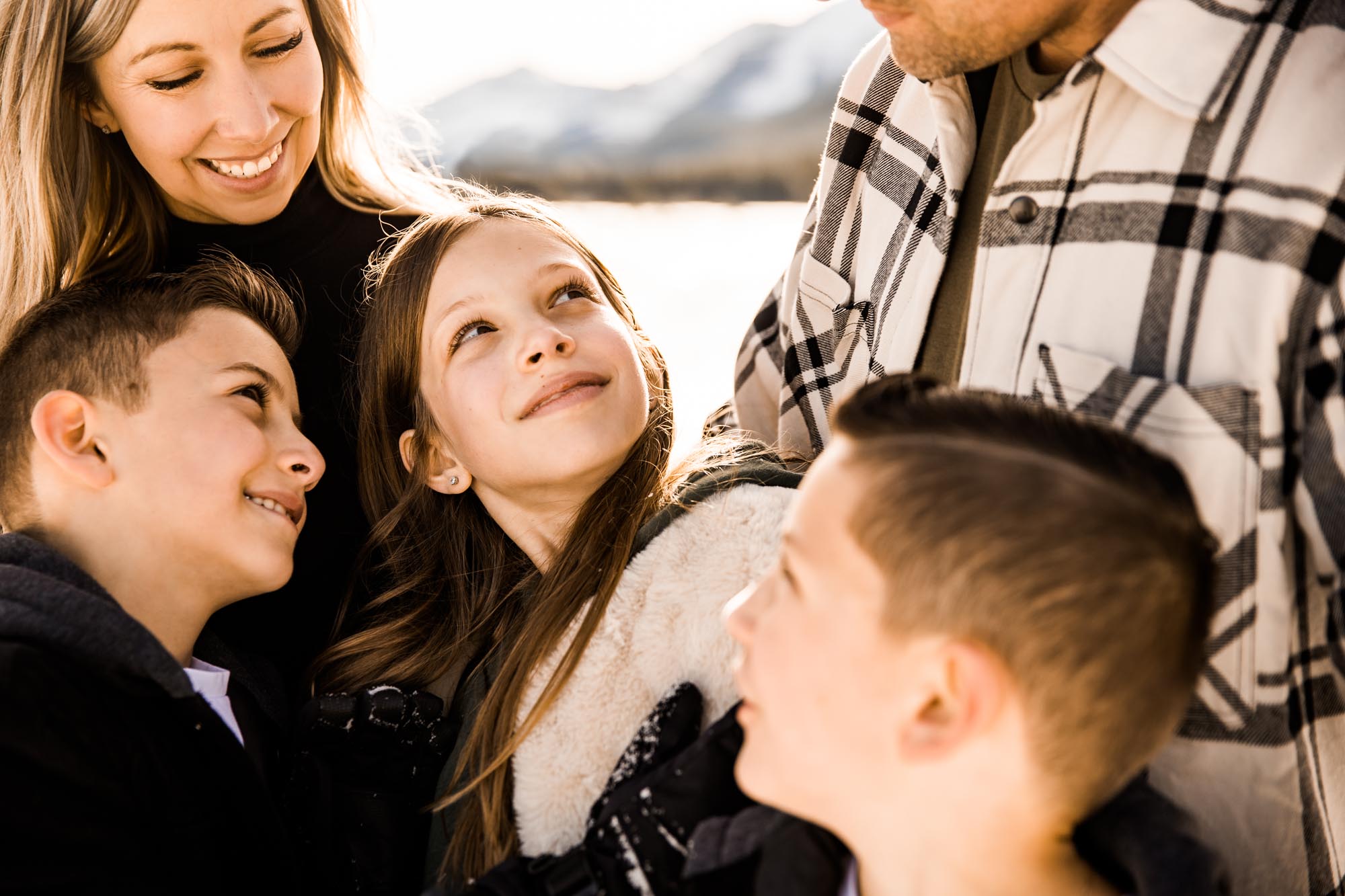 Calgary, Banff, Kananaskis Country lifestyle family photographer, family playing in the snow in the mountains during their photoshoot