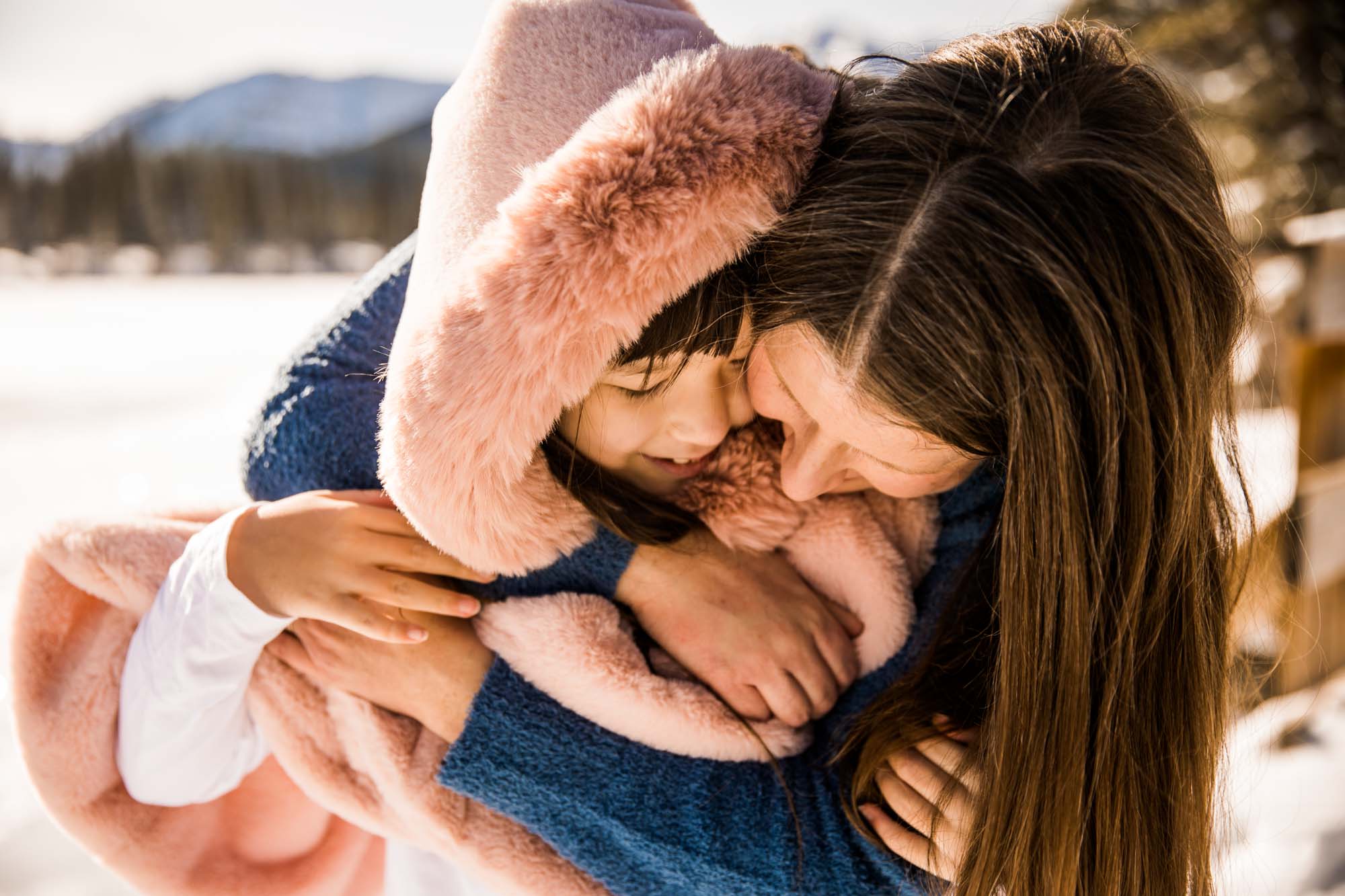 Calgary, Banff, Kananaskis Country lifestyle family photographer, family playing in the snow in the mountains during their photoshoot