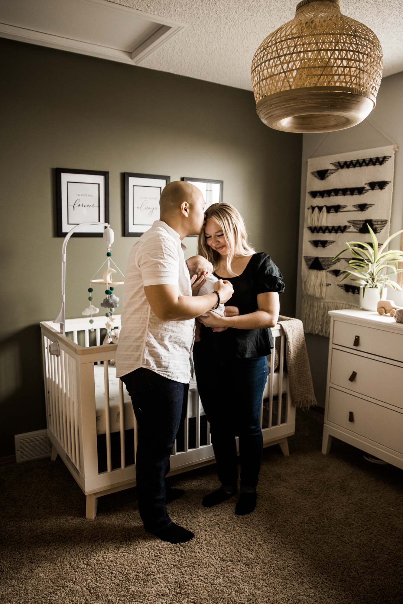 Calgary lifestyle newborn photographer, baby and his parents during his in-home newborn photoshoot
