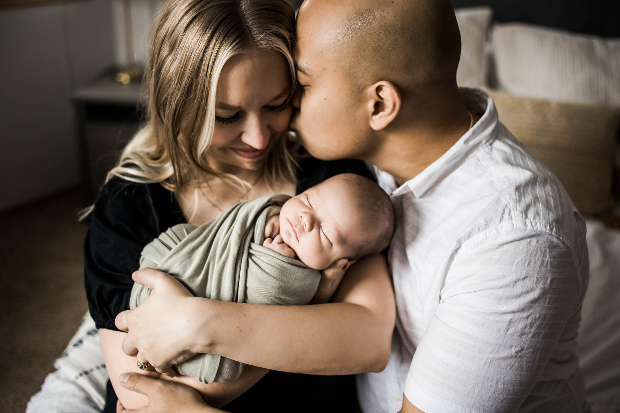Calgary lifestyle newborn photographer, baby and his parents during his in-home newborn photoshoot