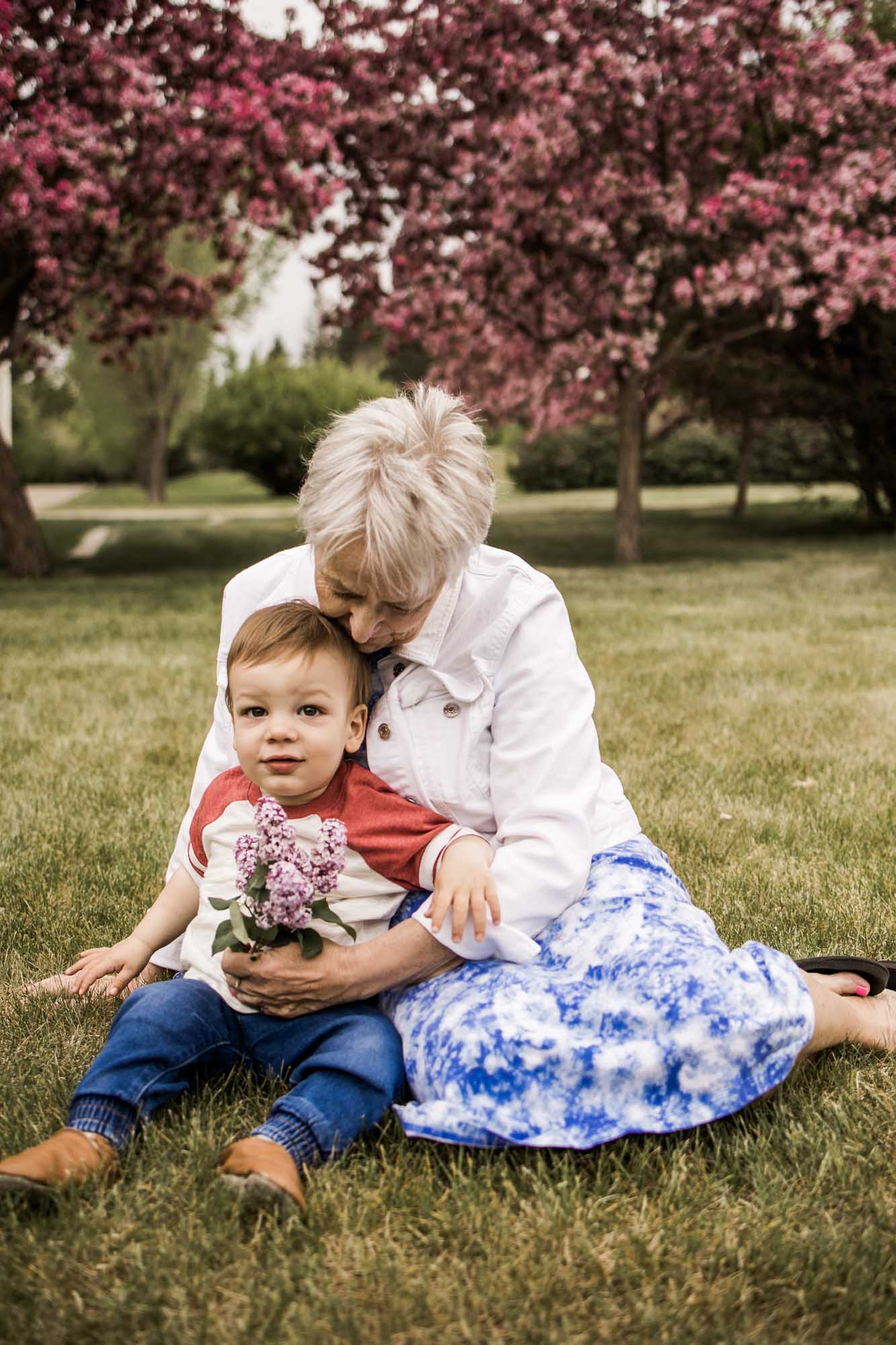 Calgary, Kananaskis, Banff lifestyle family photographer, family in front of flowers during their spring family photos