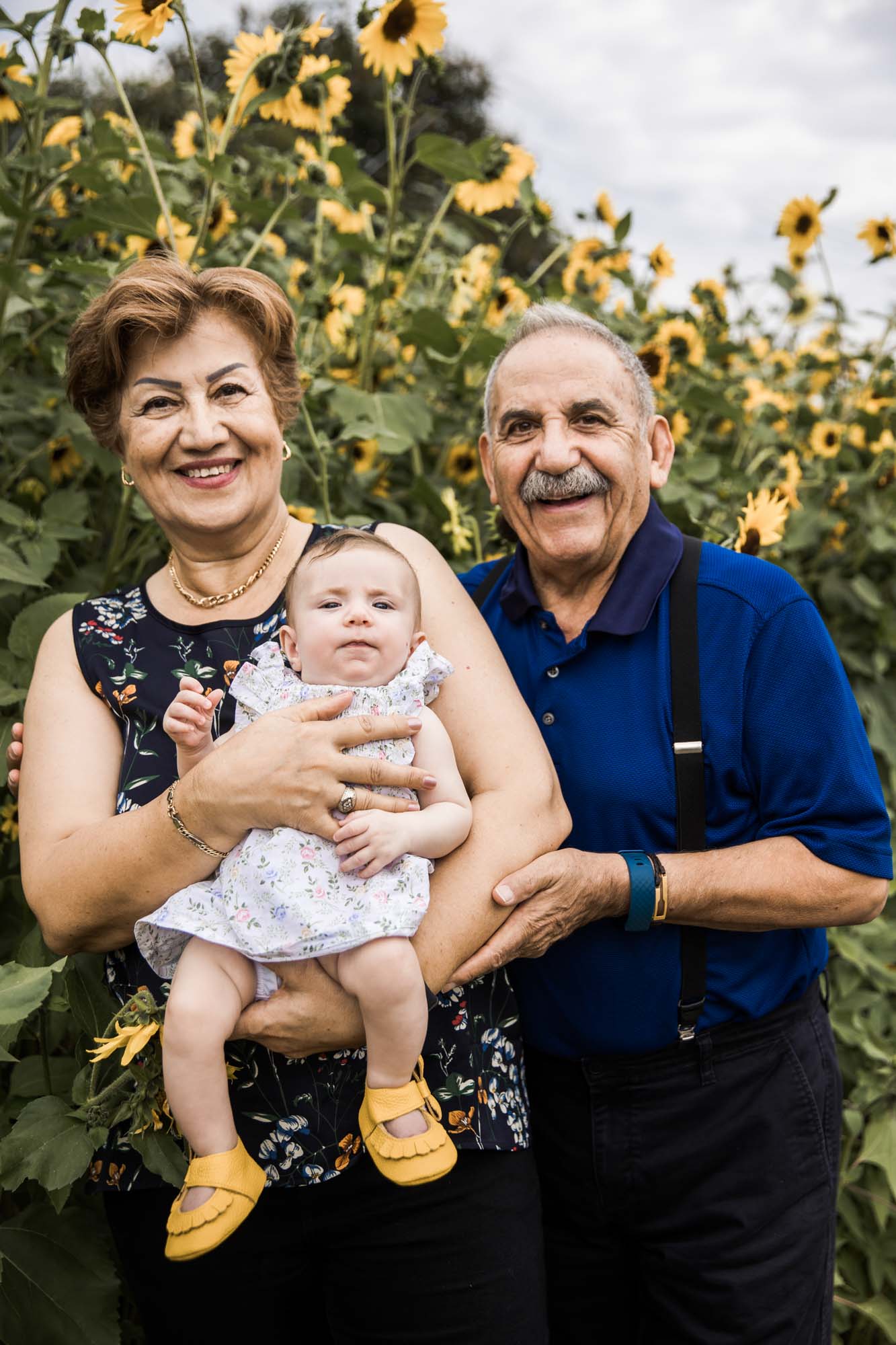 Calgary, Kananaskis, Banff lifestyle family photographer, family in front of sunflowers during their summer family photos