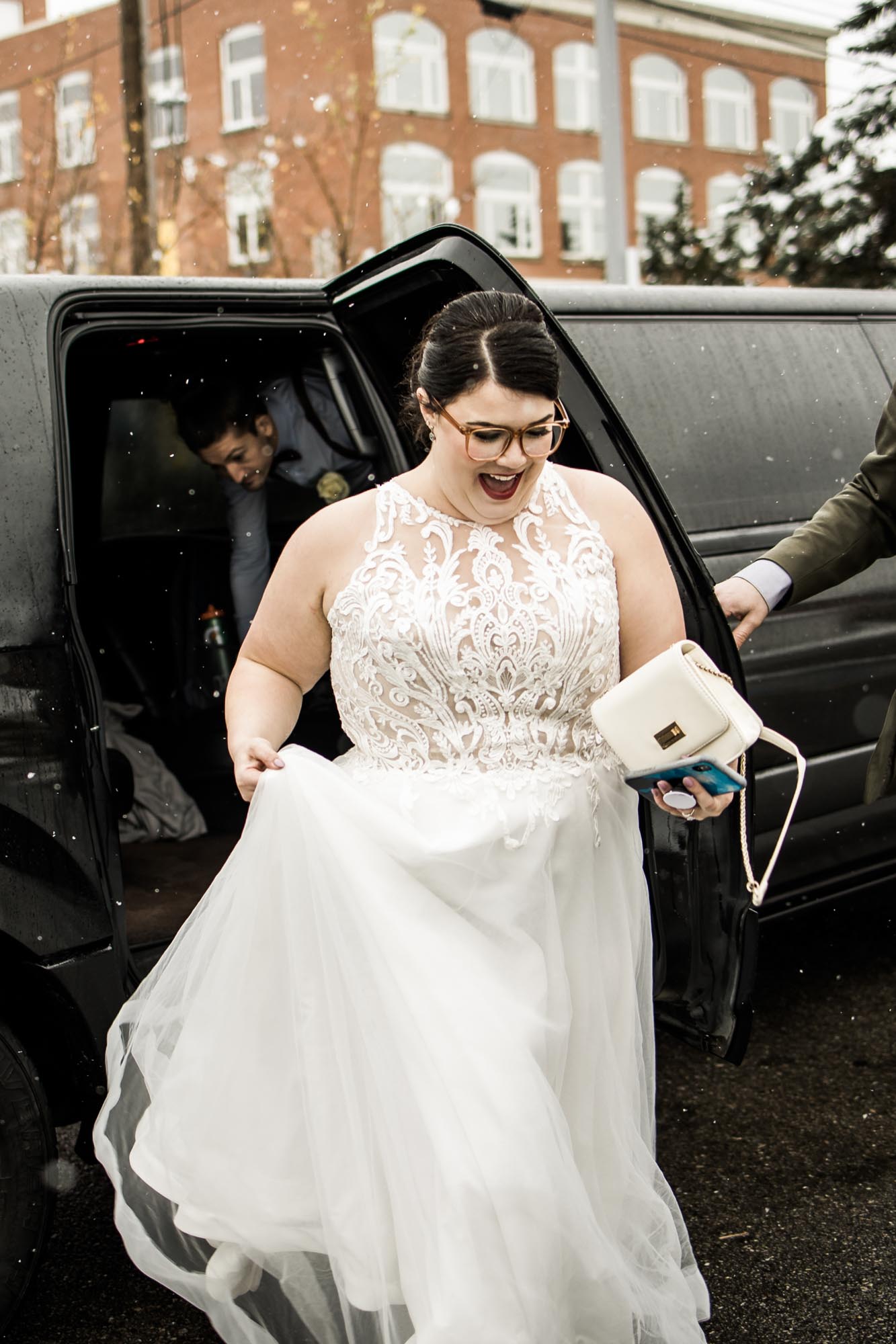 Calgary wedding photographer, bride in her dress with her bridal flowers and groom on their wedding day at Deane House Restaurant, intimate family dinner
