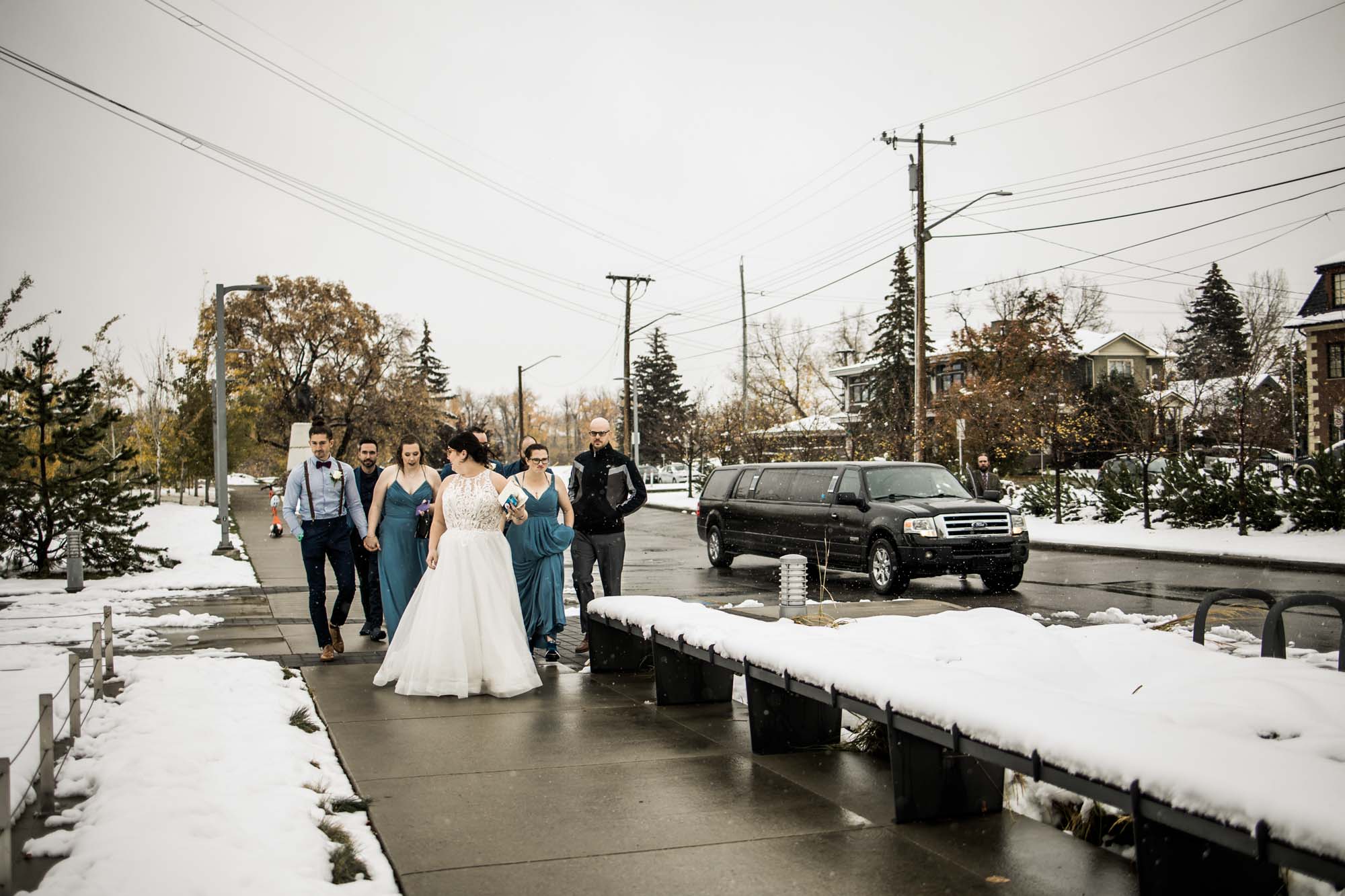 Calgary wedding photographer, bride in her dress with her bridal flowers and groom on their wedding day at Deane House Restaurant, intimate family dinner