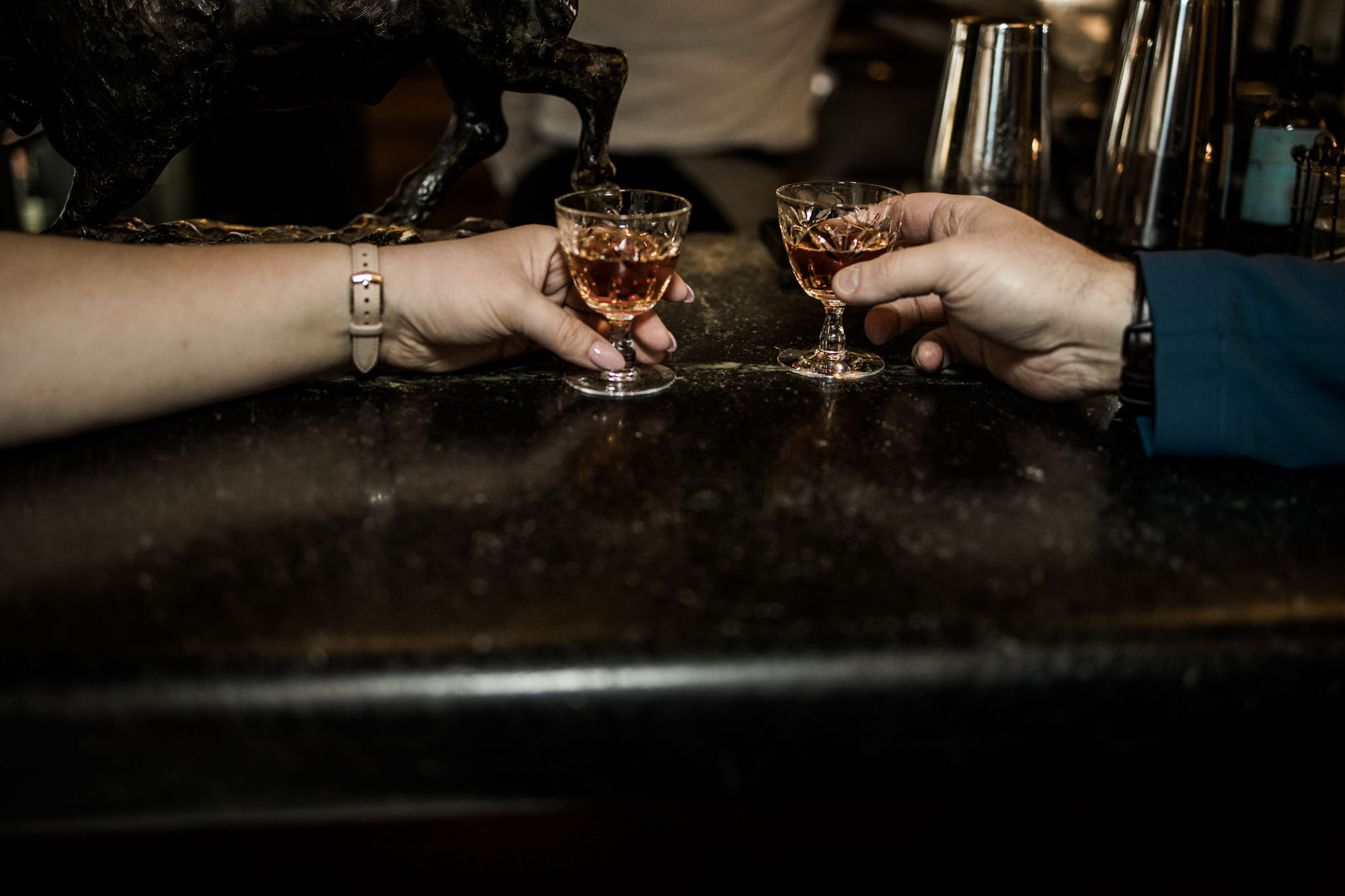 Calgary wedding photographer, bride in her dress with her bridal flowers and groom on their wedding day at Deane House Restaurant, intimate family dinner