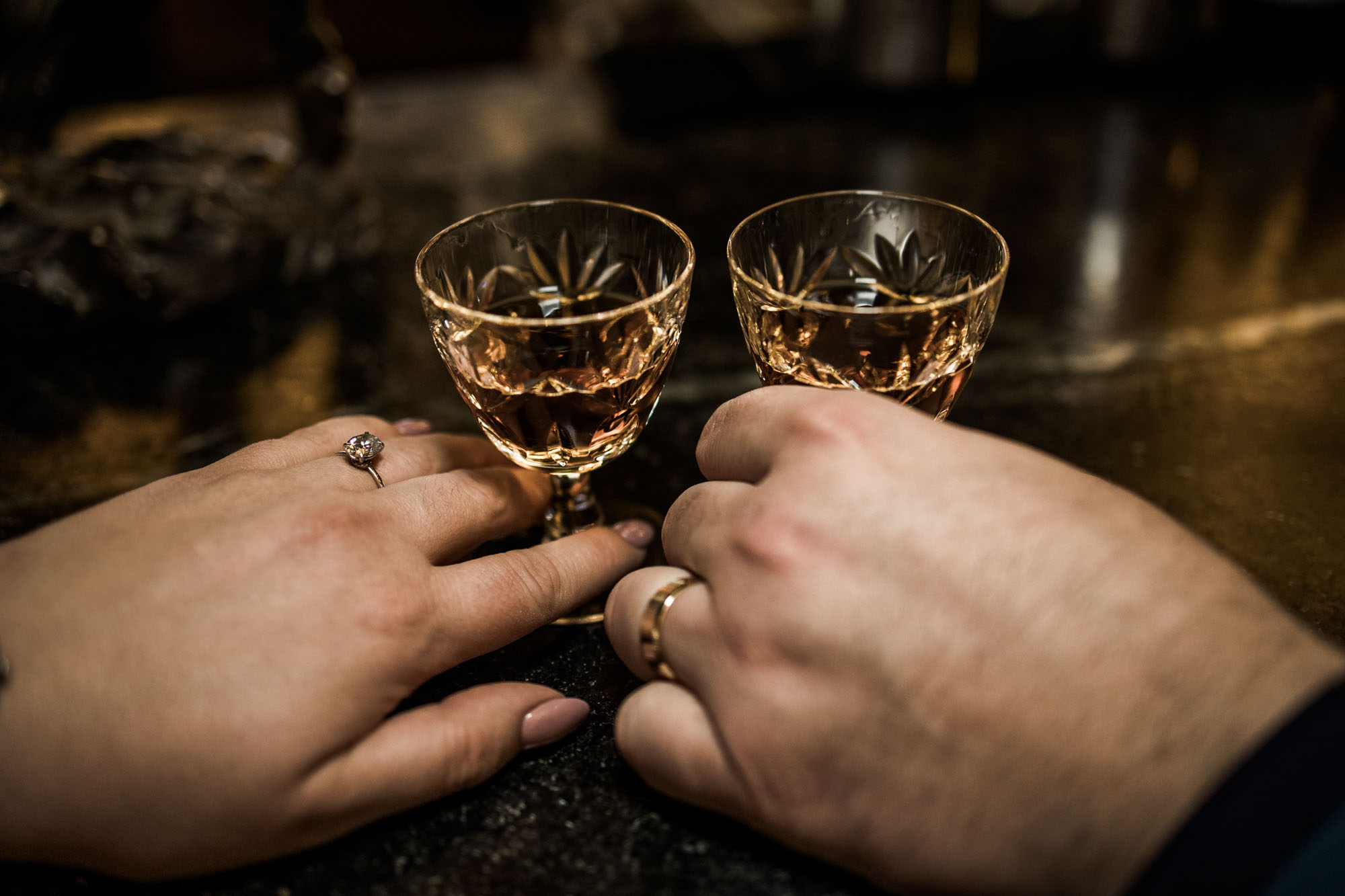 Calgary wedding photographer, bride in her dress with her bridal flowers and groom on their wedding day at Deane House Restaurant, intimate family dinner