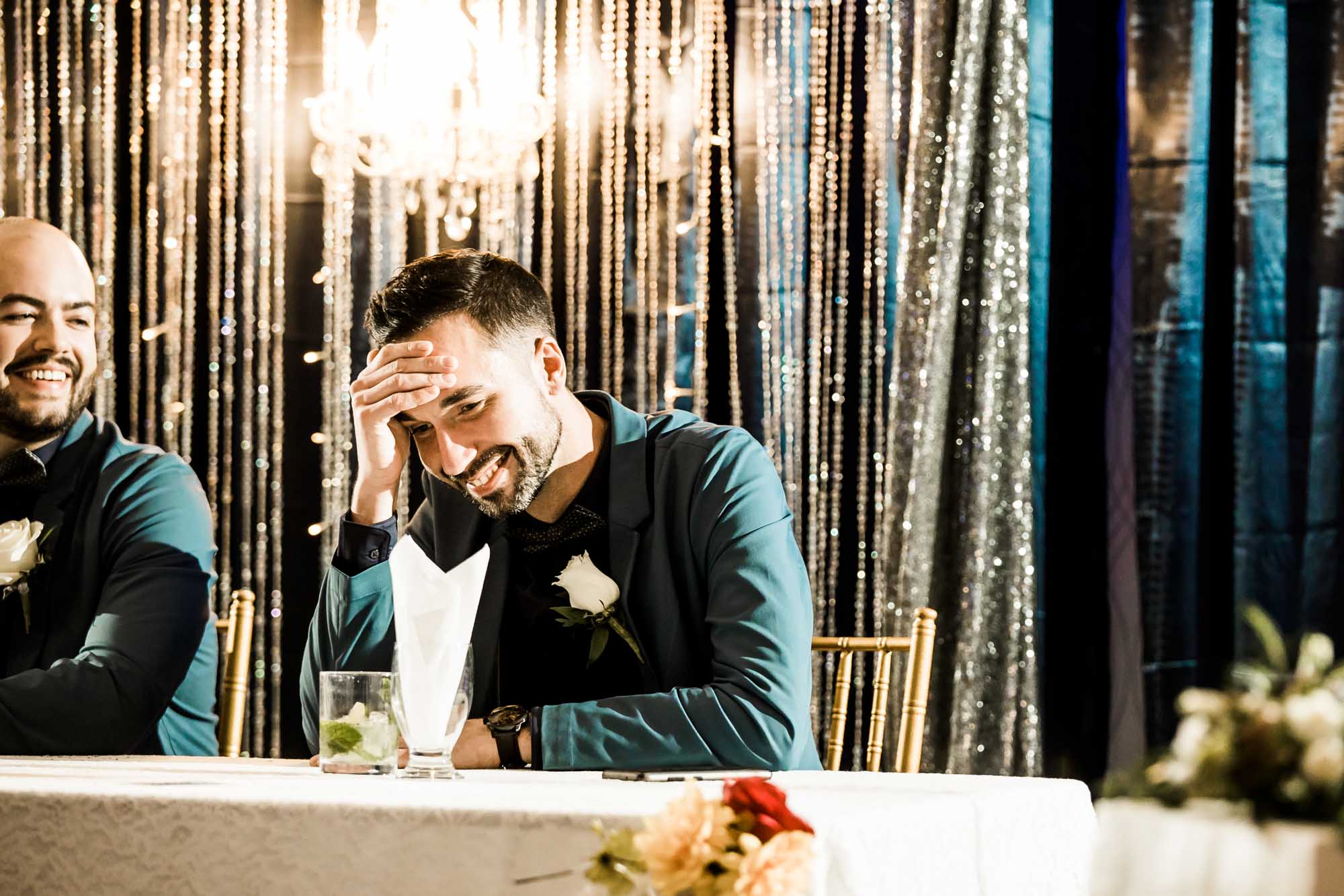 Calgary wedding photographer, bride in her dress with her bridal flowers and groom on their wedding day at White Diamond Conference Center, large wedding reception space