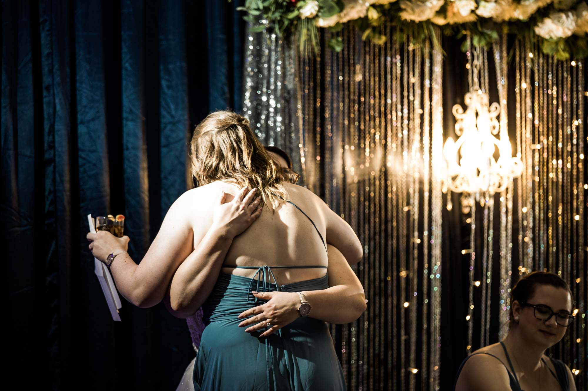 Calgary wedding photographer, bride in her dress with her bridal flowers and groom on their wedding day at White Diamond Conference Center, large wedding reception space