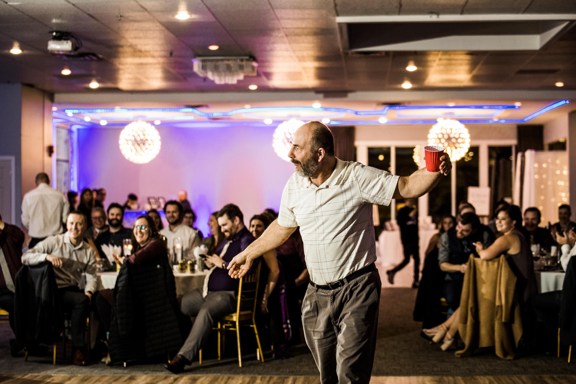 Calgary wedding photographer, bride in her dress with her bridal flowers and groom on their wedding day at White Diamond Conference Center, large wedding reception space
