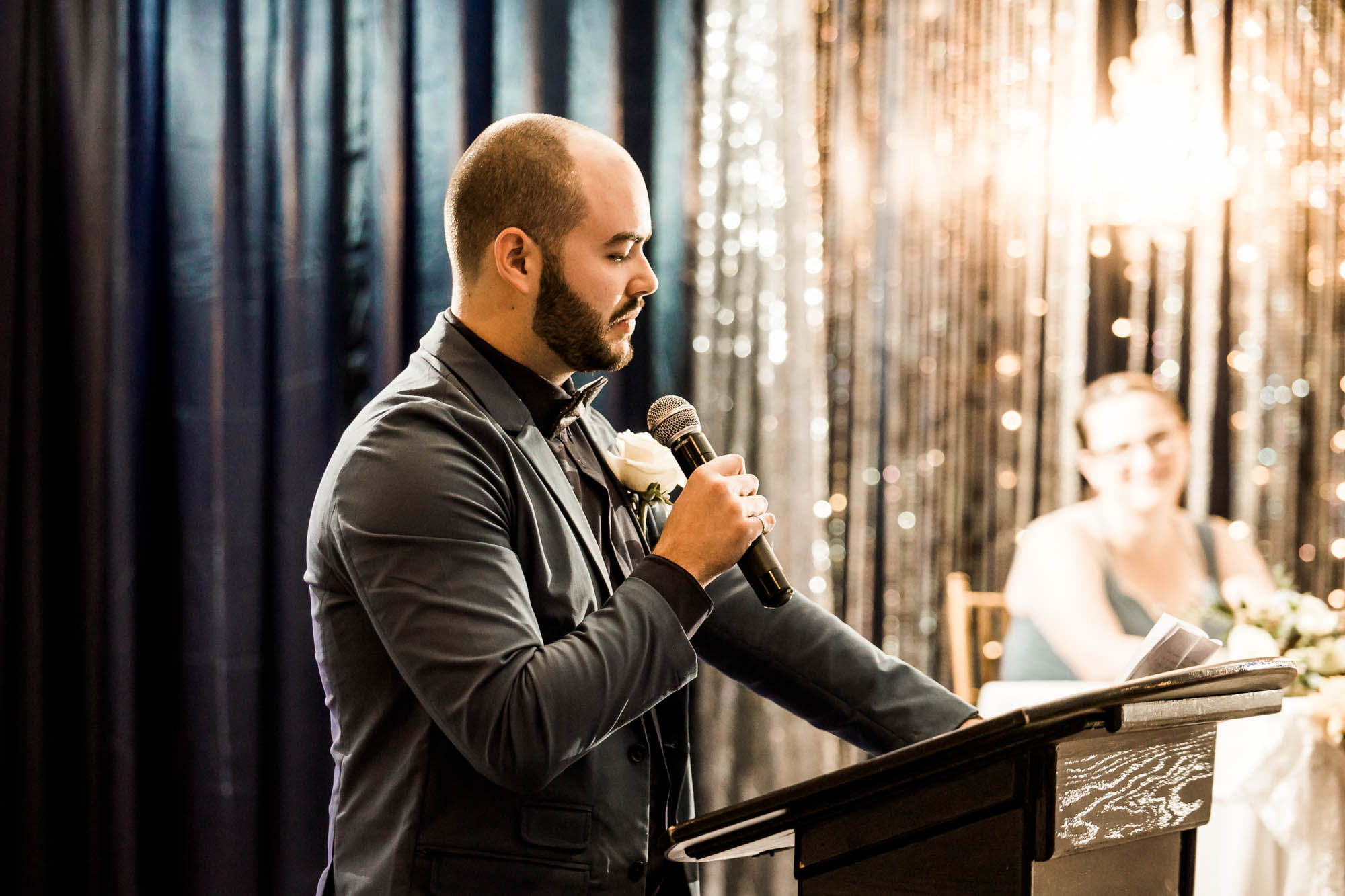 Calgary wedding photographer, bride in her dress with her bridal flowers and groom on their wedding day at White Diamond Conference Center, large wedding reception space