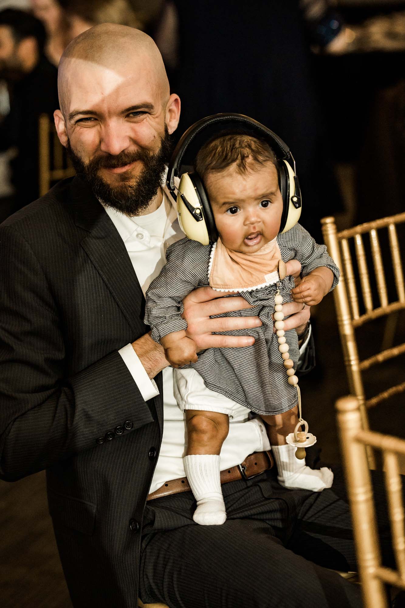 Calgary wedding photographer, bride in her dress with her bridal flowers and groom on their wedding day at White Diamond Conference Center, large wedding reception space