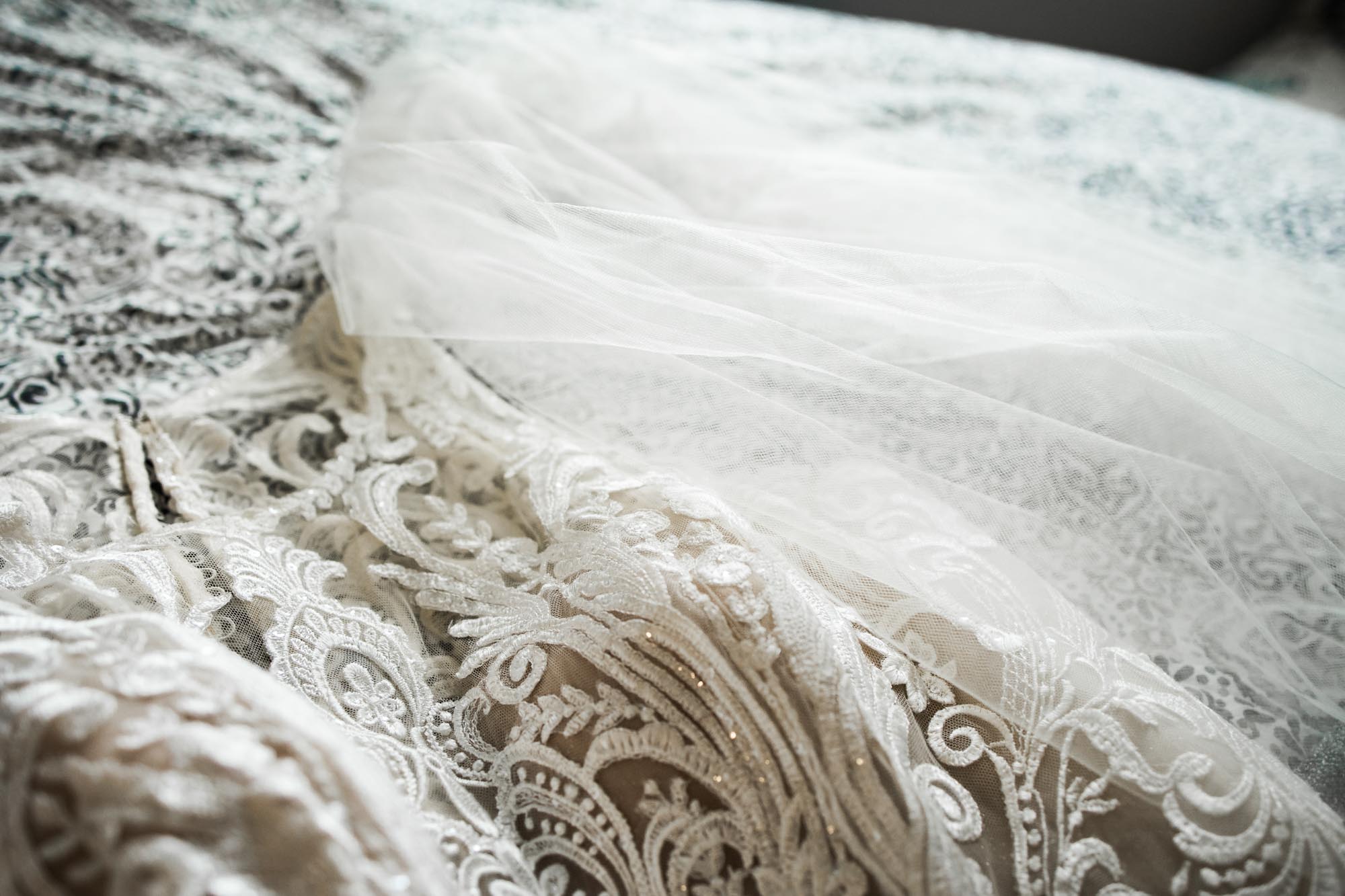 Calgary wedding photographer, bride in her dress with her bridal flowers getting ready