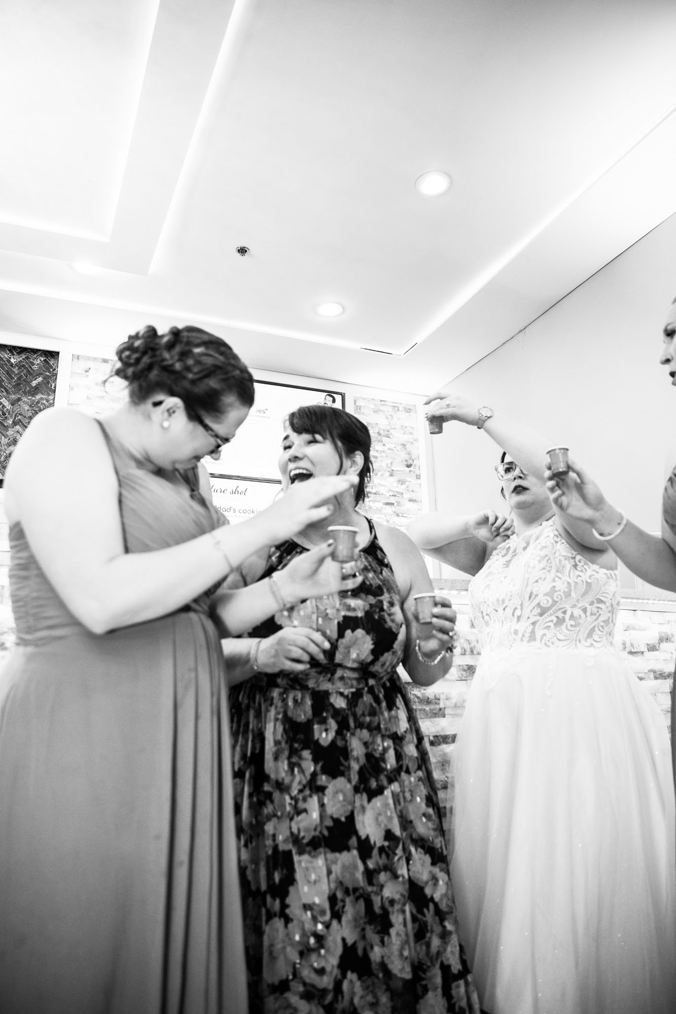 Calgary wedding photographer, bride in her dress with her bridal flowers and groom on their wedding day at White Diamond Conference Center, large wedding reception space