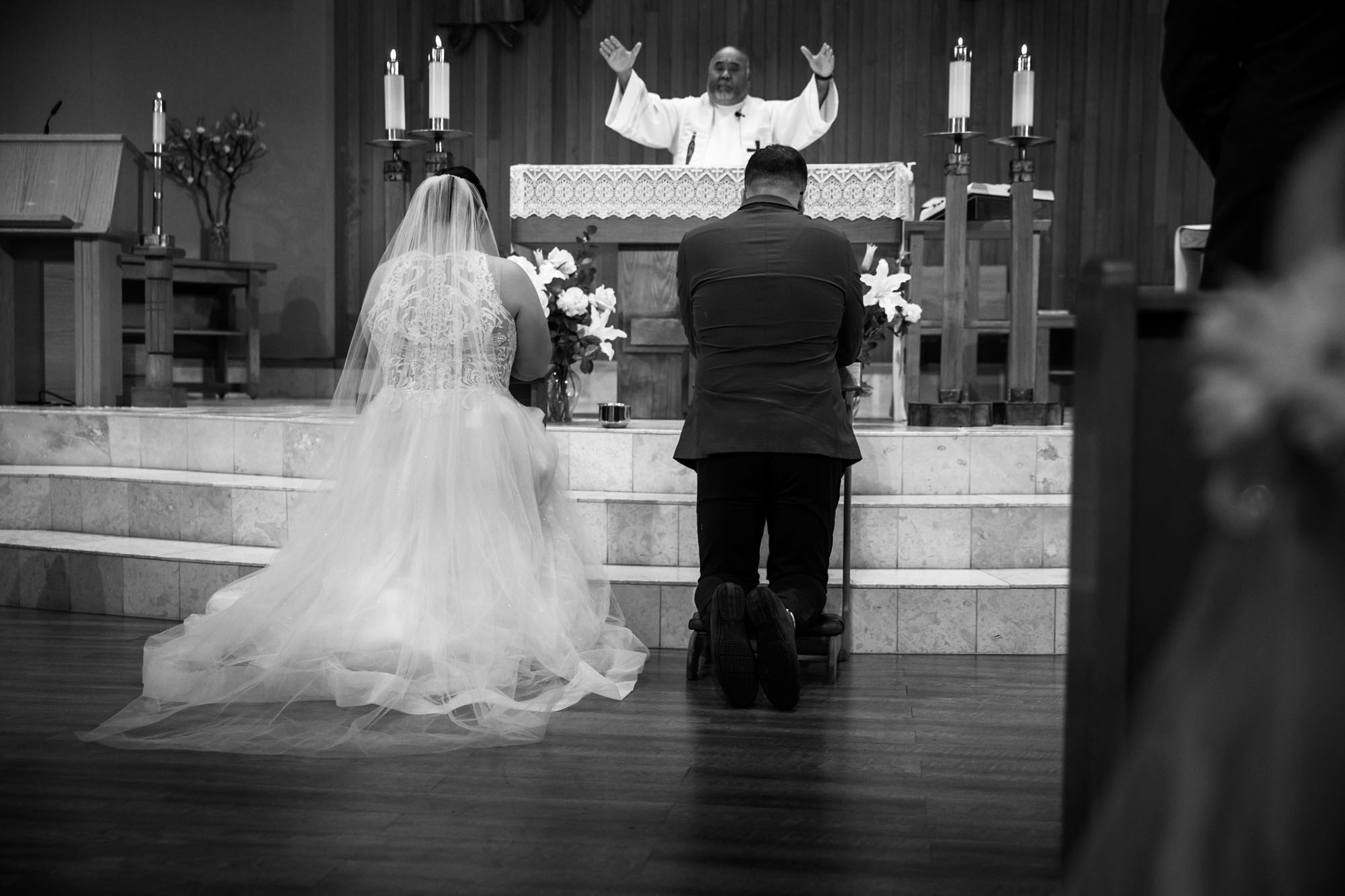 Calgary wedding photographer, bride in her dress with her bridal flowers and groom on their wedding day at St Peter's Church