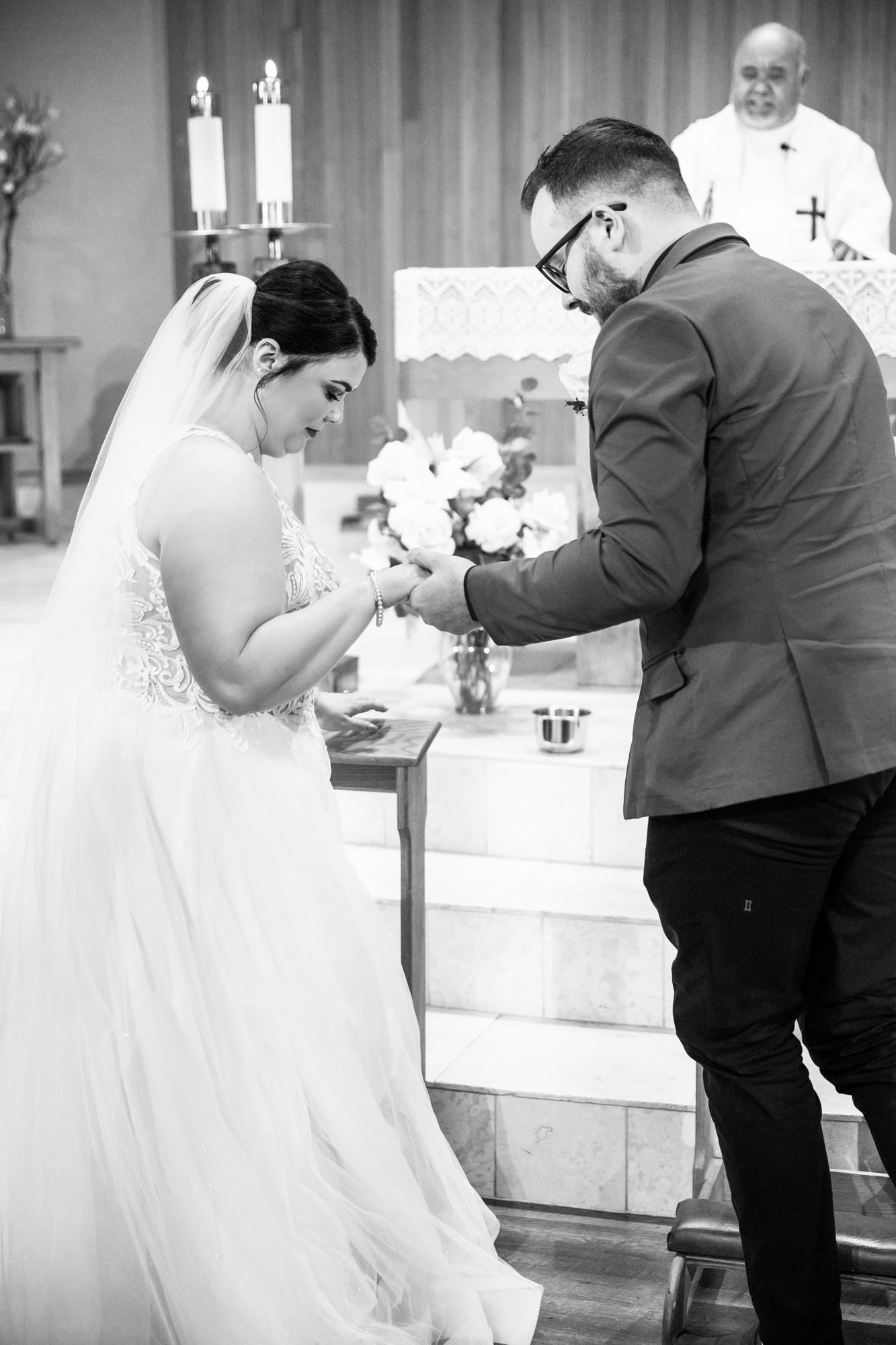 Calgary wedding photographer, bride in her dress with her bridal flowers and groom on their wedding day at St Peter's Church