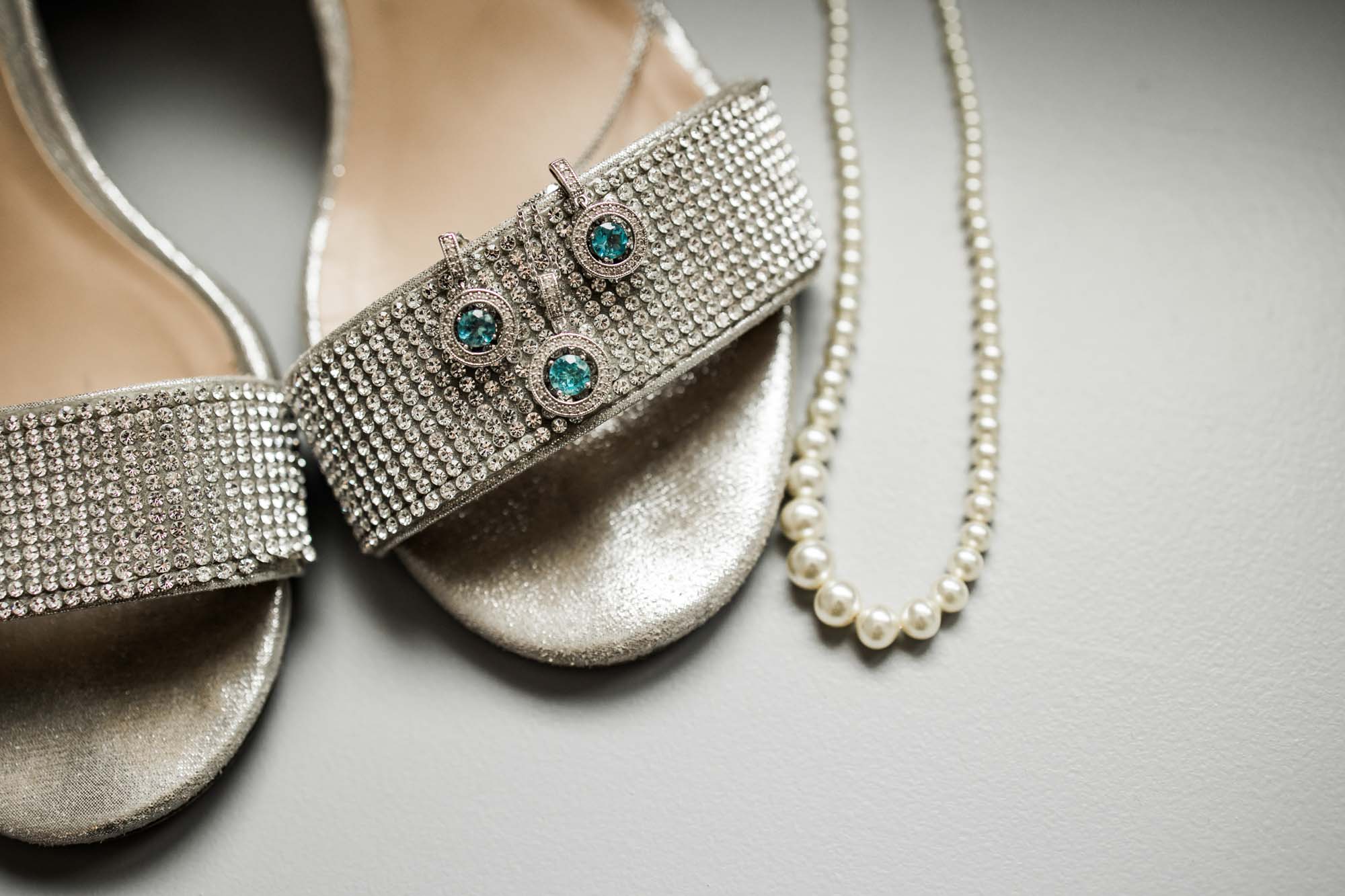 Calgary wedding photographer, bride in her dress with her bridal flowers getting ready
