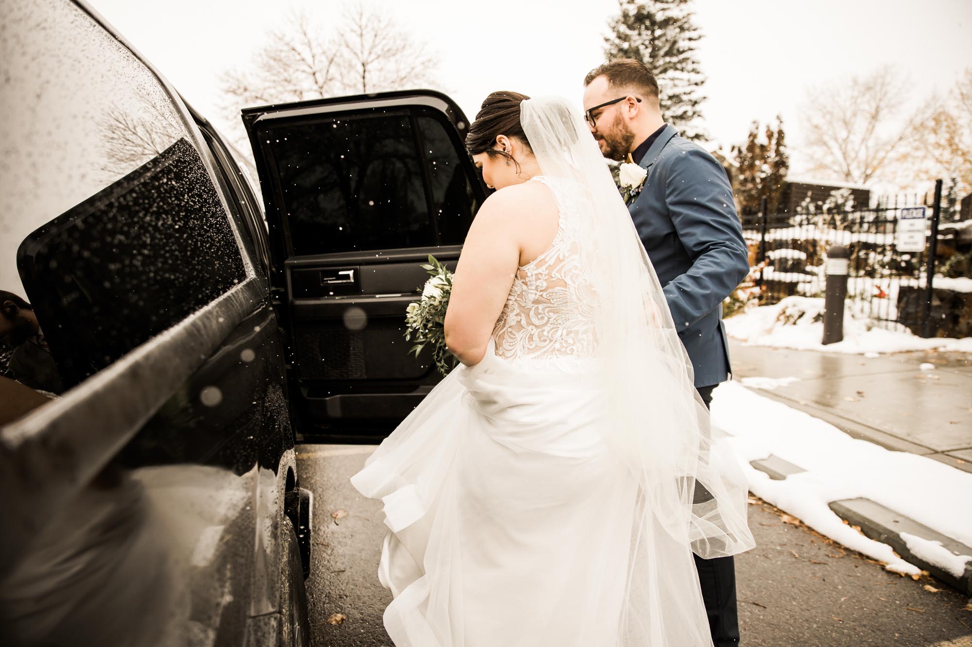 Calgary wedding photographer, bride in her dress with her bridal flowers and groom on their wedding day at St Peter's Church