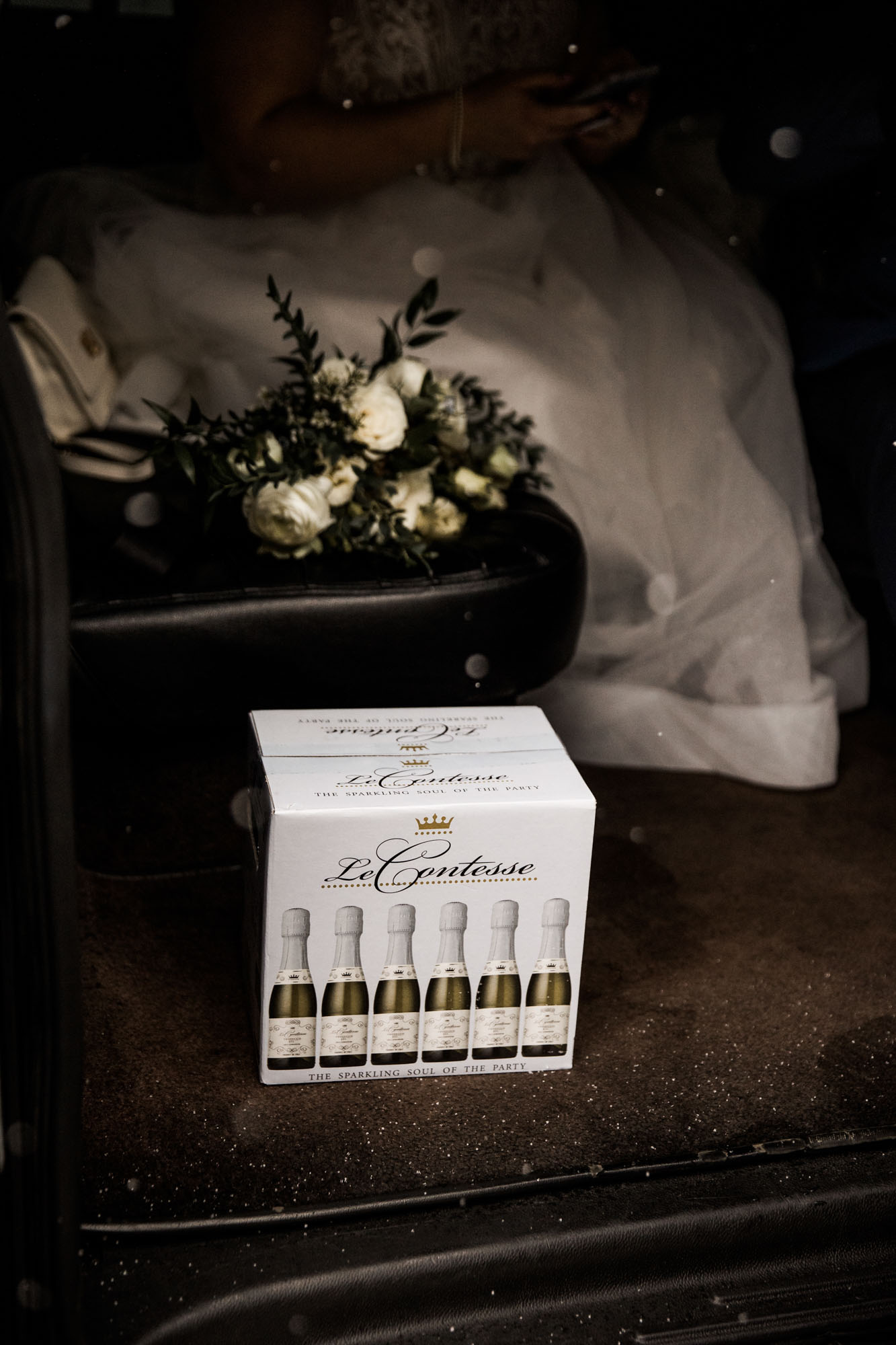 Calgary wedding photographer, bride in her dress with her bridal flowers and groom on their wedding day at St Patrick's Island, winter snow and fall leaves