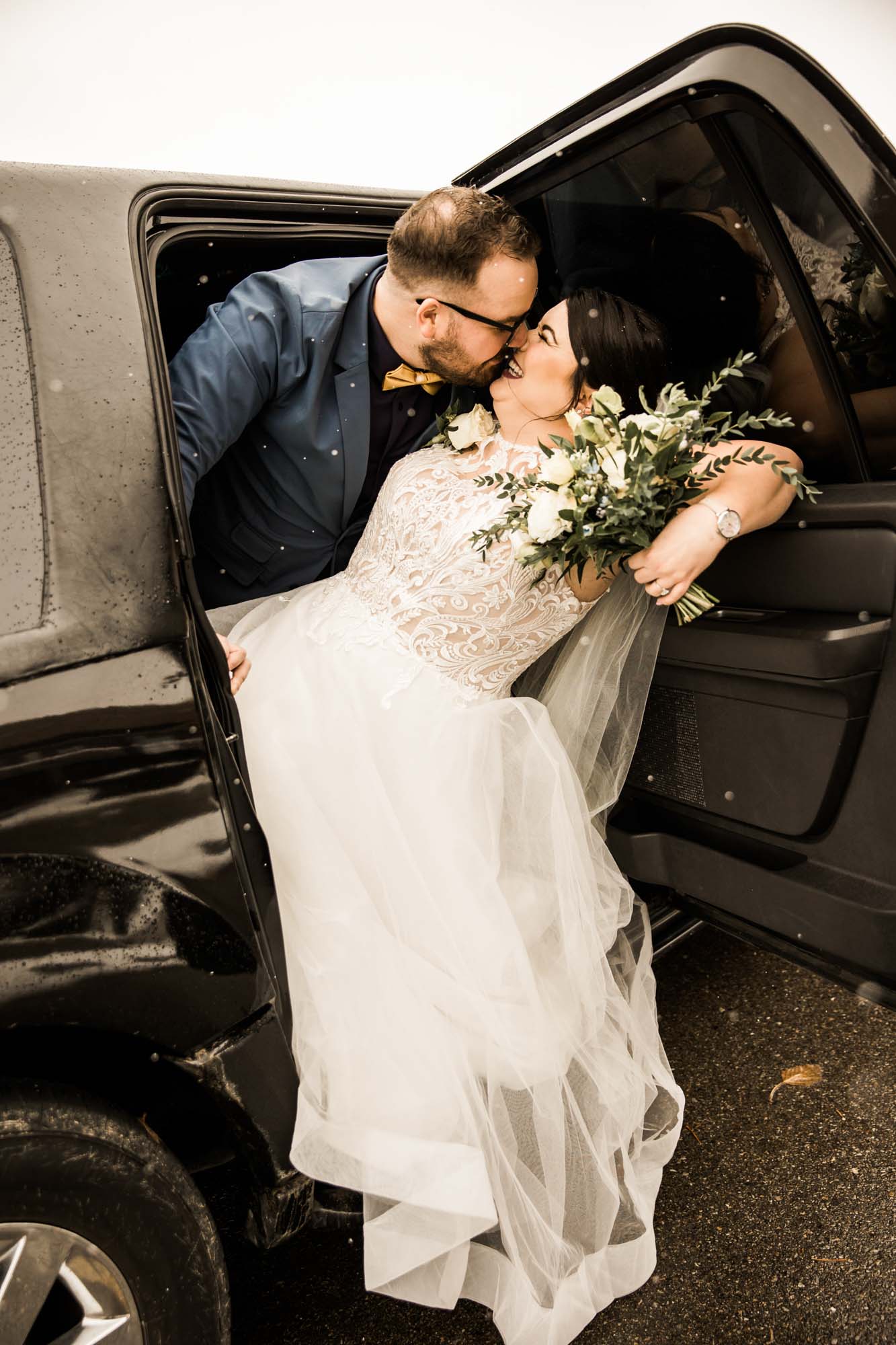 Calgary wedding photographer, bride in her dress with her bridal flowers and groom on their wedding day at St Patrick's Island, winter snow and fall leaves