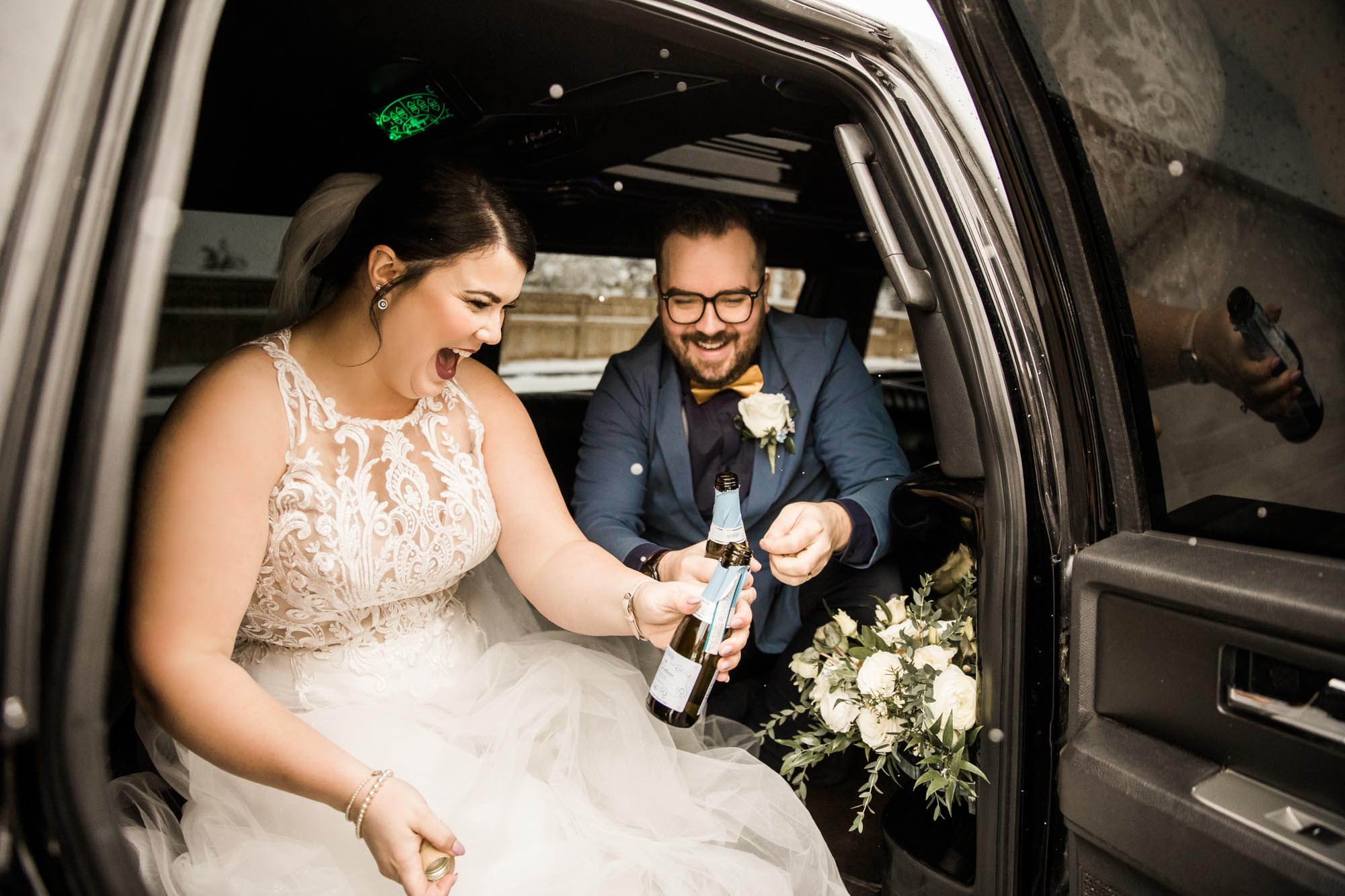 Calgary wedding photographer, bride in her dress with her bridal flowers and groom on their wedding day at St Patrick's Island, winter snow and fall leaves