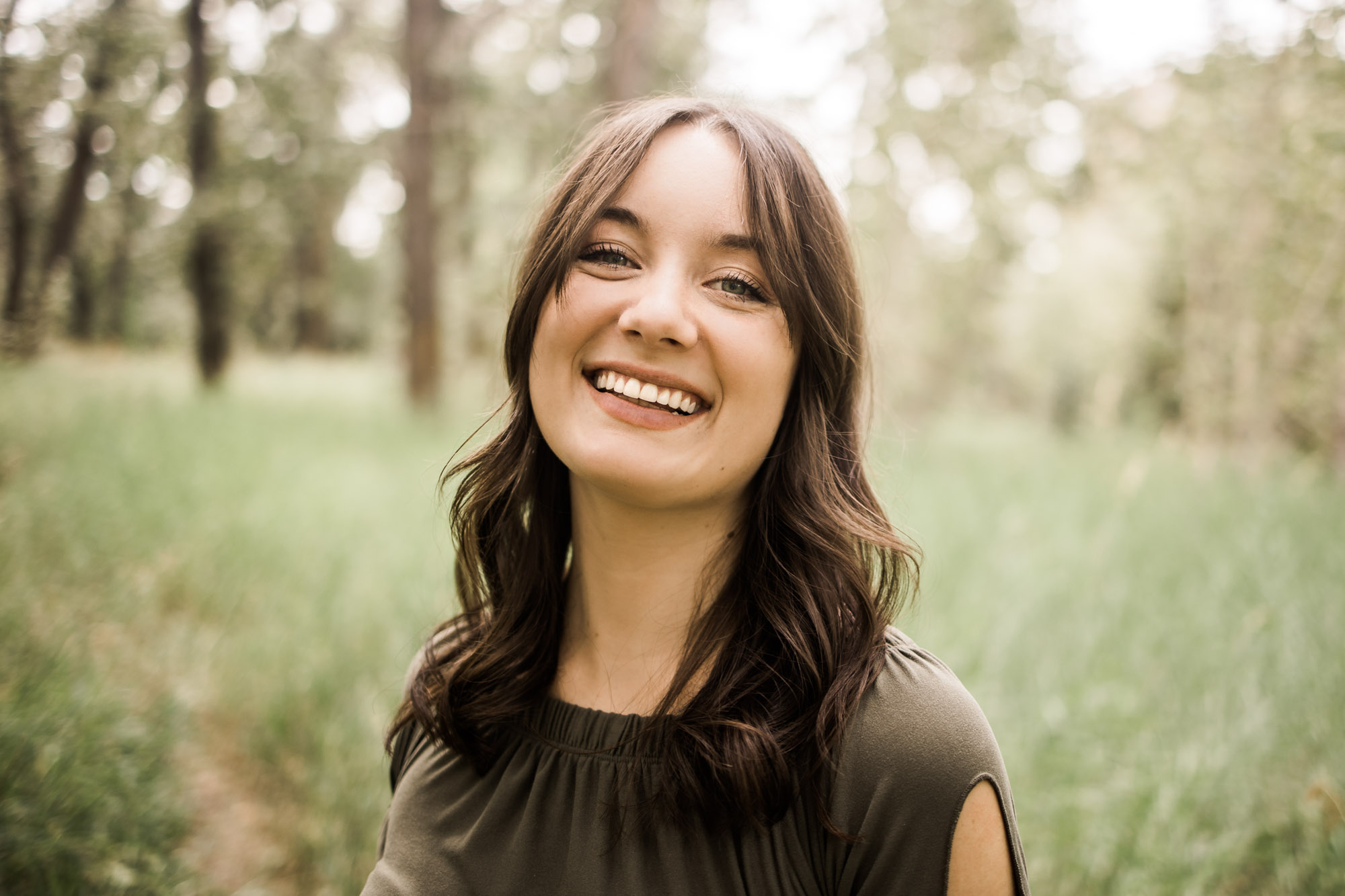 Calgary branding and headshot photographer, copywriter posing for her headshots and branding photos at Bowness Park in the summer
