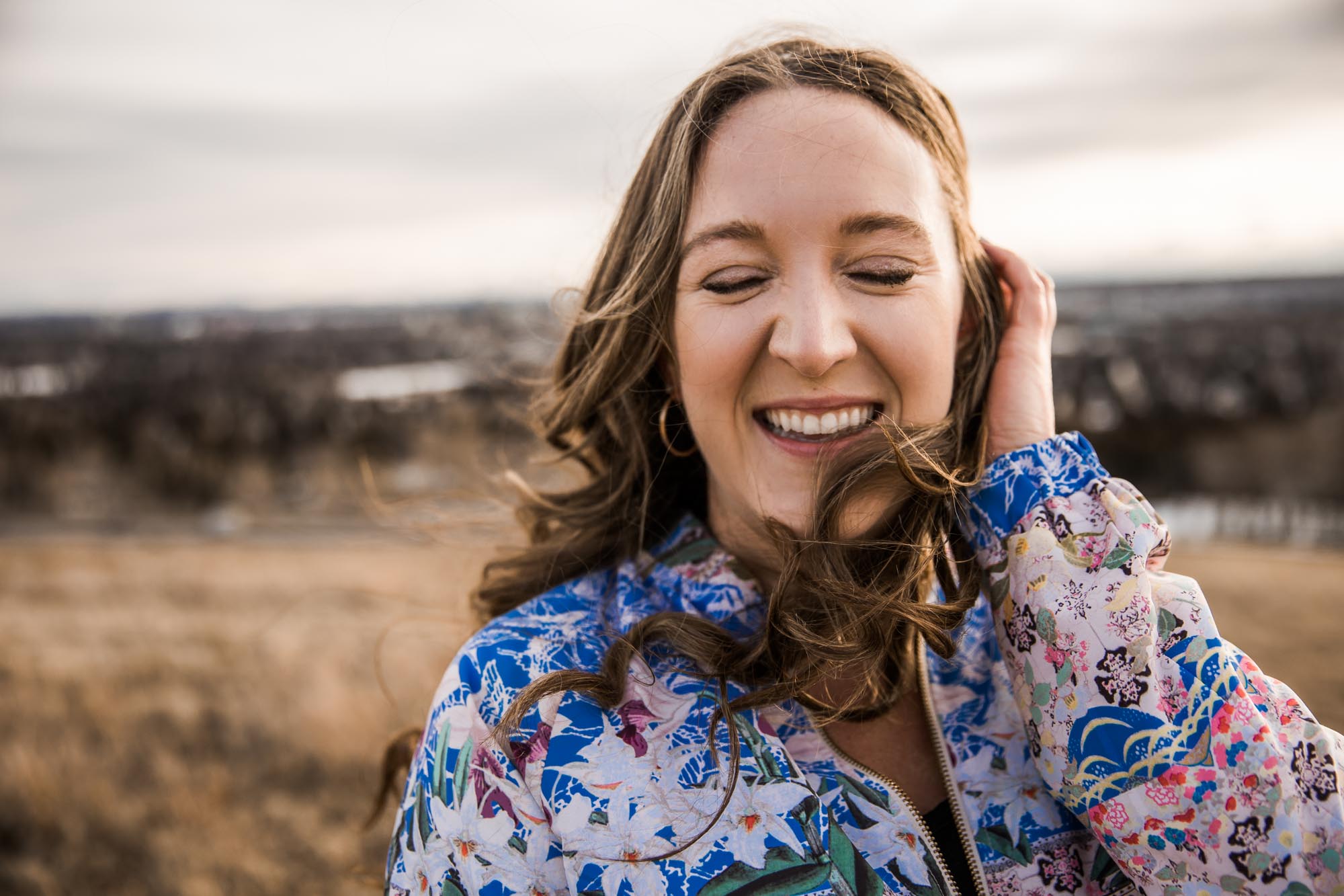 Calgary branding and headshot photographer, copywriter posing for her headshots and branding photos at Nose Hill Park