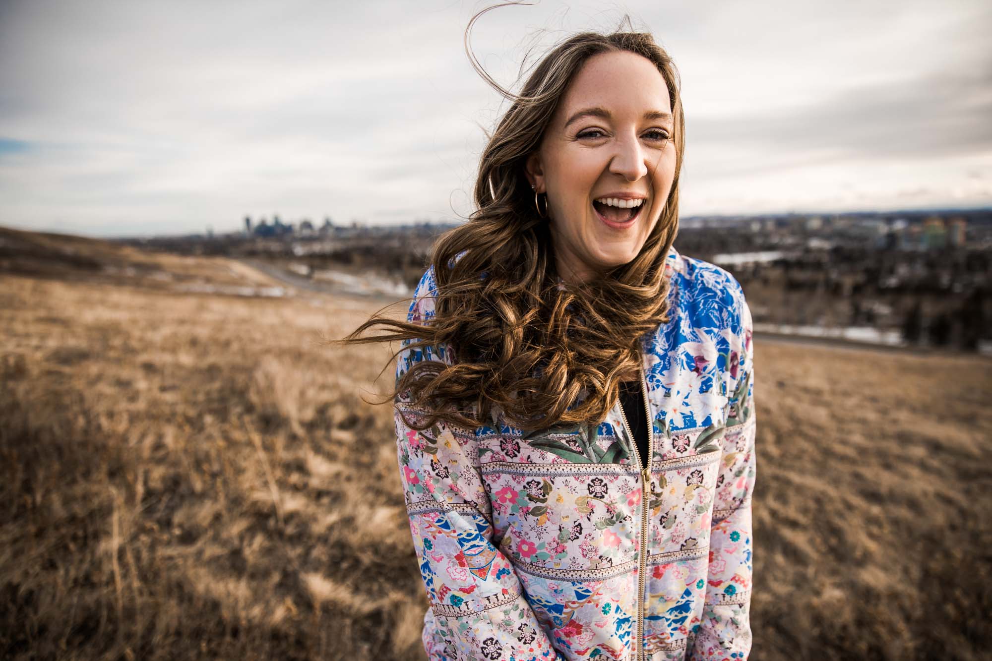 Calgary branding and headshot photographer, copywriter posing for her headshots and branding photos at Nose Hill Park
