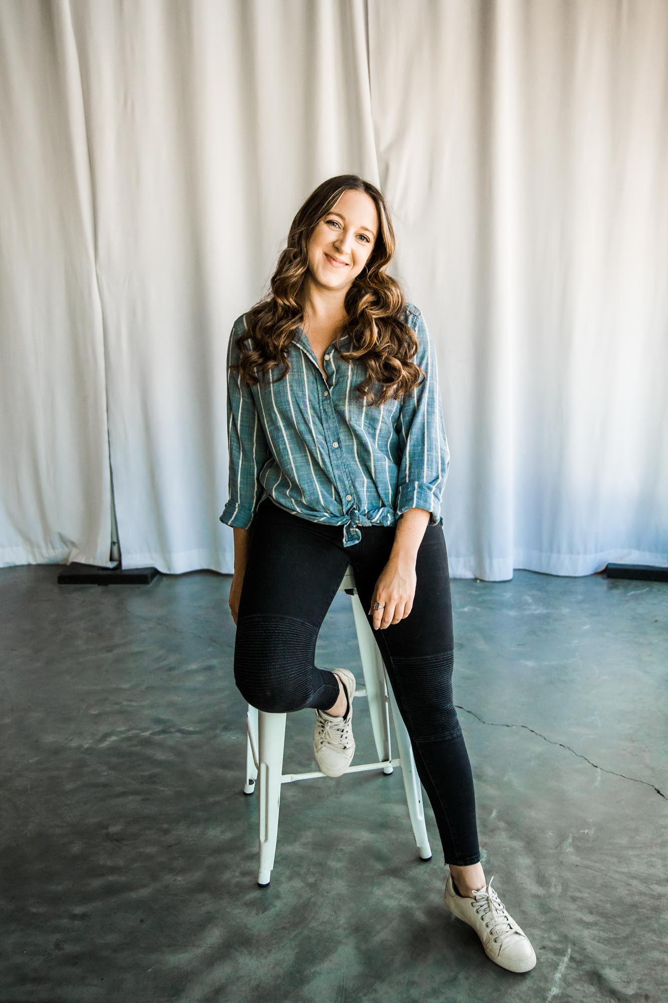 Calgary branding and headshot photographer, copywriter posing for her headshots and branding photos at the Hub at Deerfoot City mall