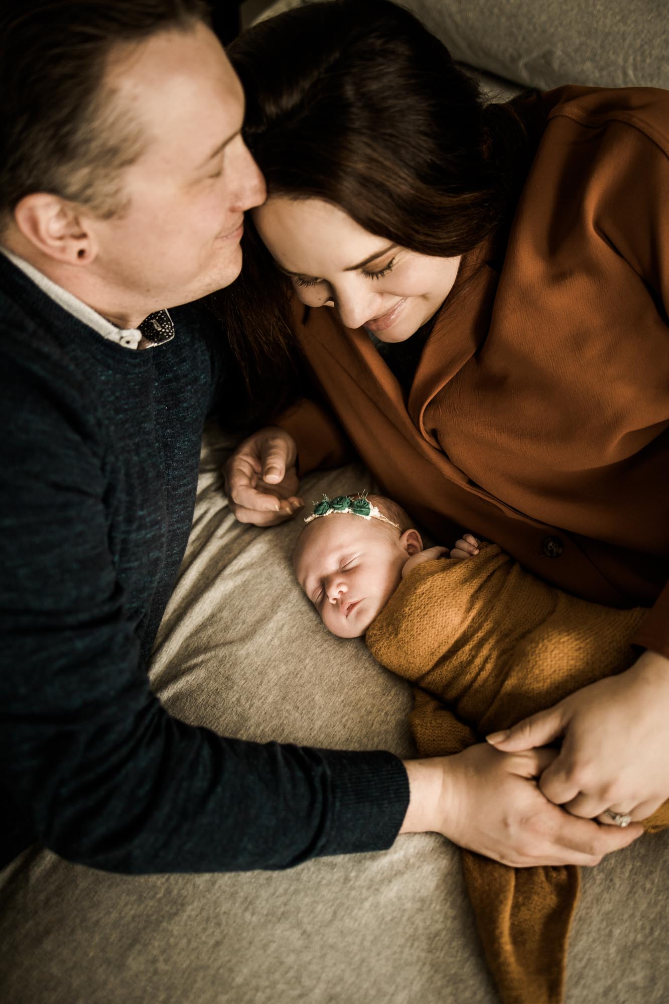 Calgary lifestyle newborn photographer and maternity photographer, baby with her parents during her in-home newborn session