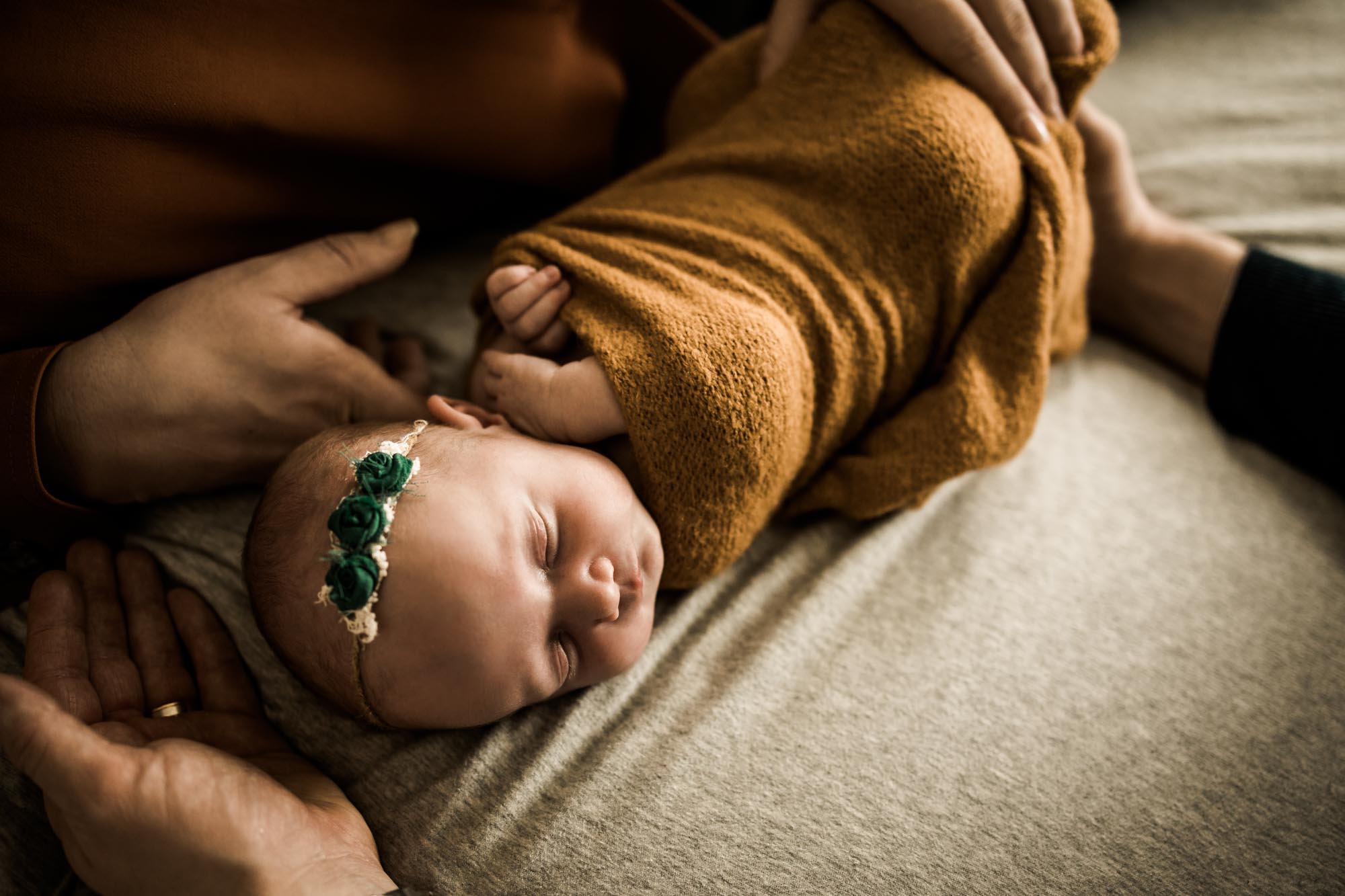 Calgary lifestyle newborn photographer and maternity photographer, baby with her parents during her in-home newborn session