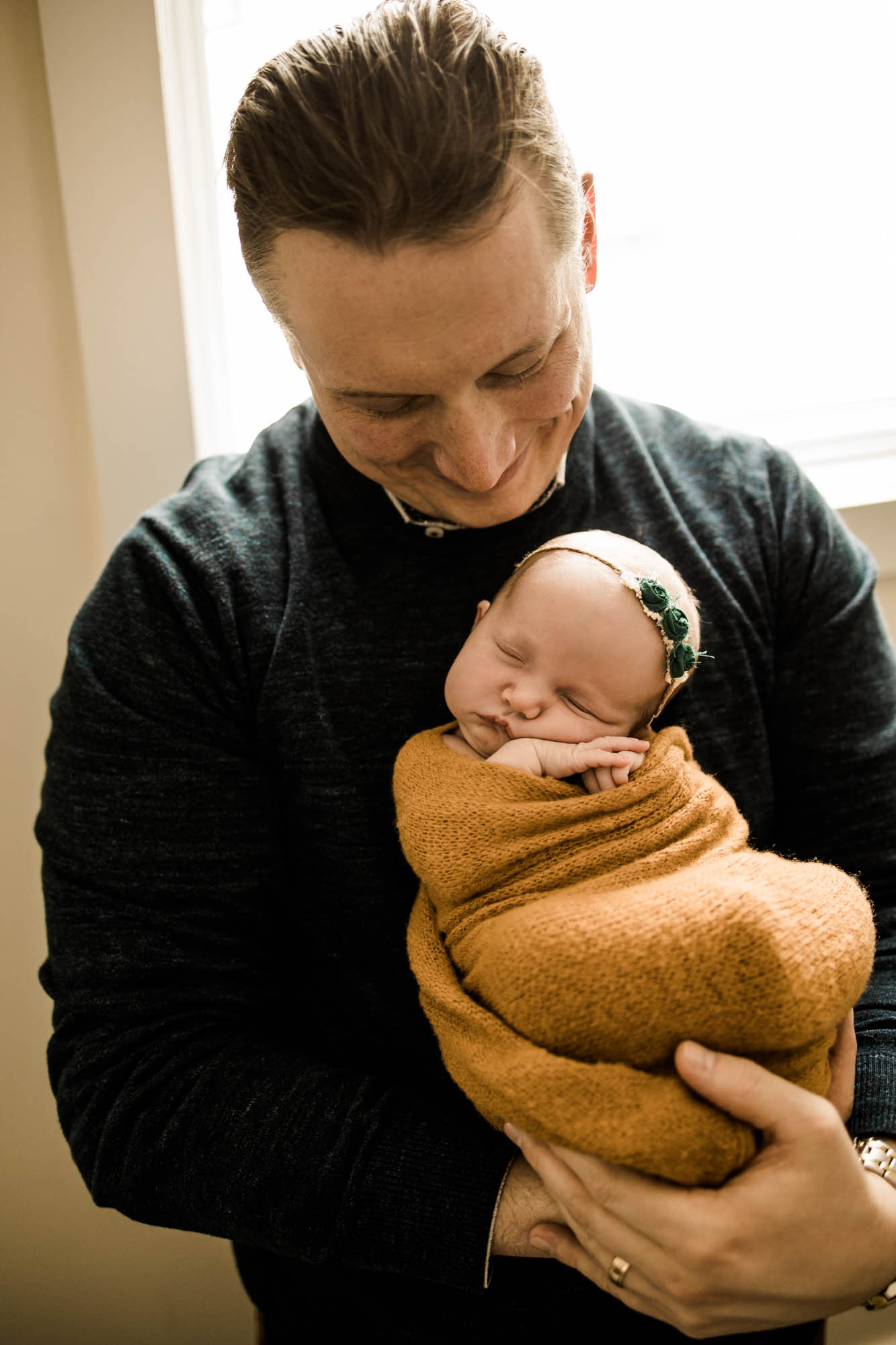 Calgary lifestyle newborn photographer and maternity photographer, baby with her parents during her in-home newborn session