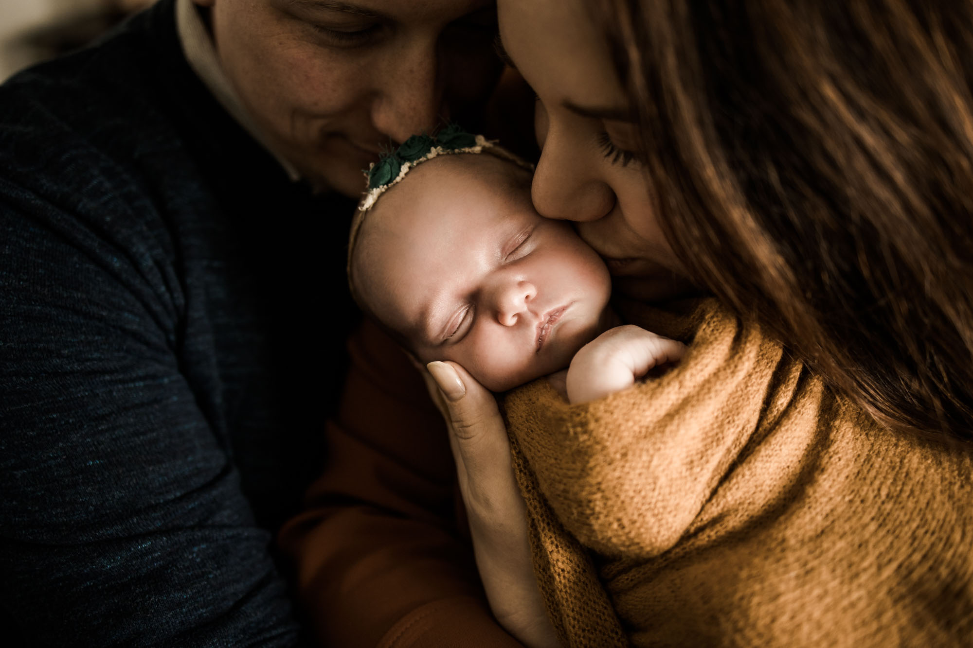 Calgary lifestyle newborn photographer and maternity photographer, baby with her parents during her in-home newborn session